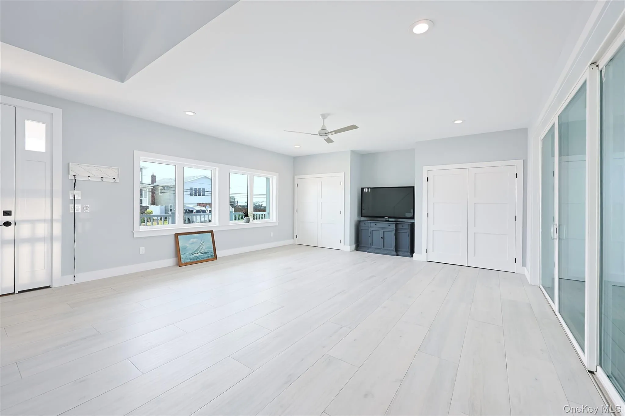 Unfurnished living room featuring ceiling fan, recessed lighting, and light wood-style flooring Unfurnished living room featuring ceiling fan, recessed lighting, and light wood-style flooring