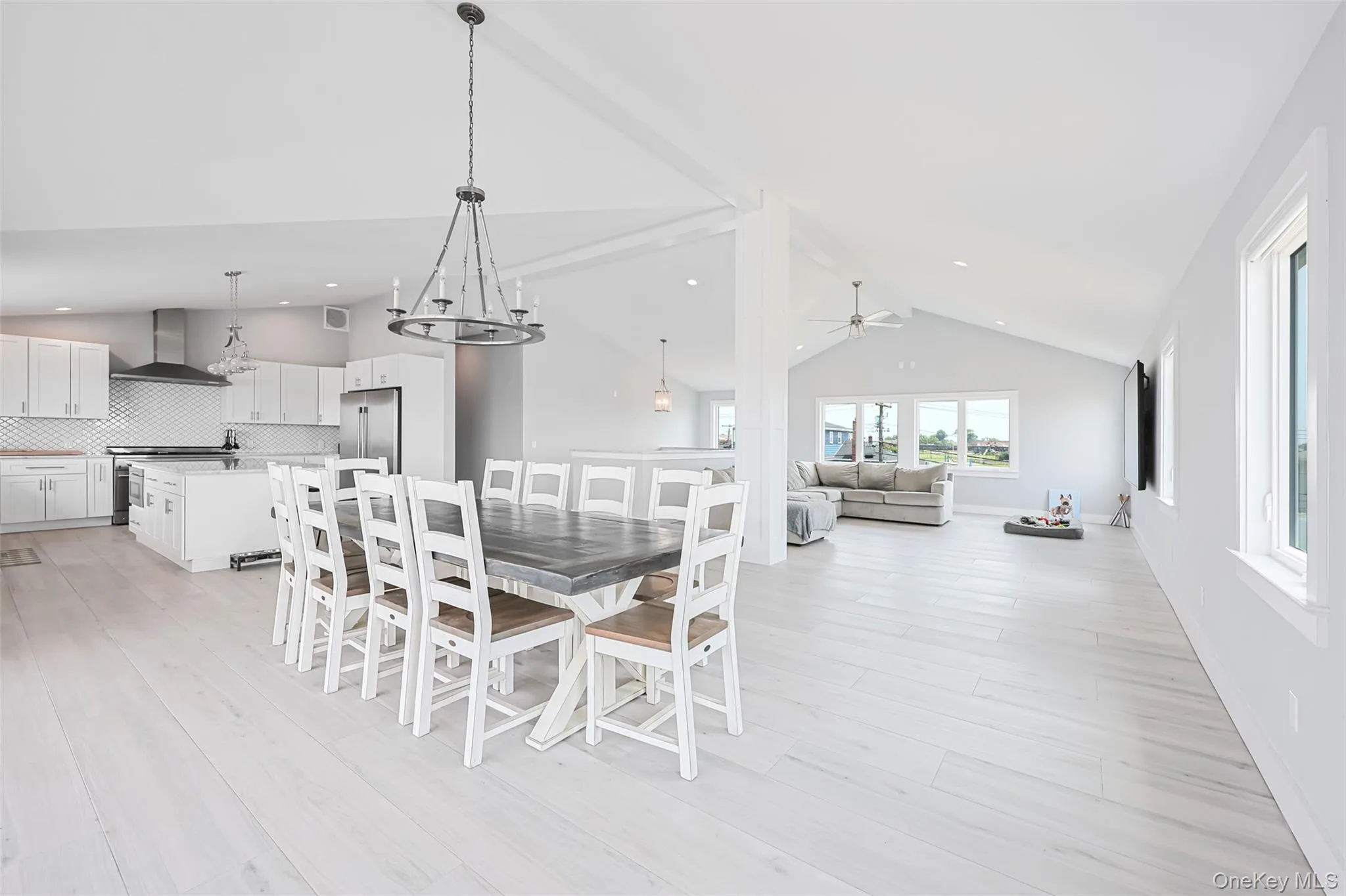 Dining area featuring ceiling fan, high vaulted ceiling, light wood-style floors, and recessed lighting Dining area featuring ceiling fan, high vaulted ceiling, light wood-style floors, and recessed lighting