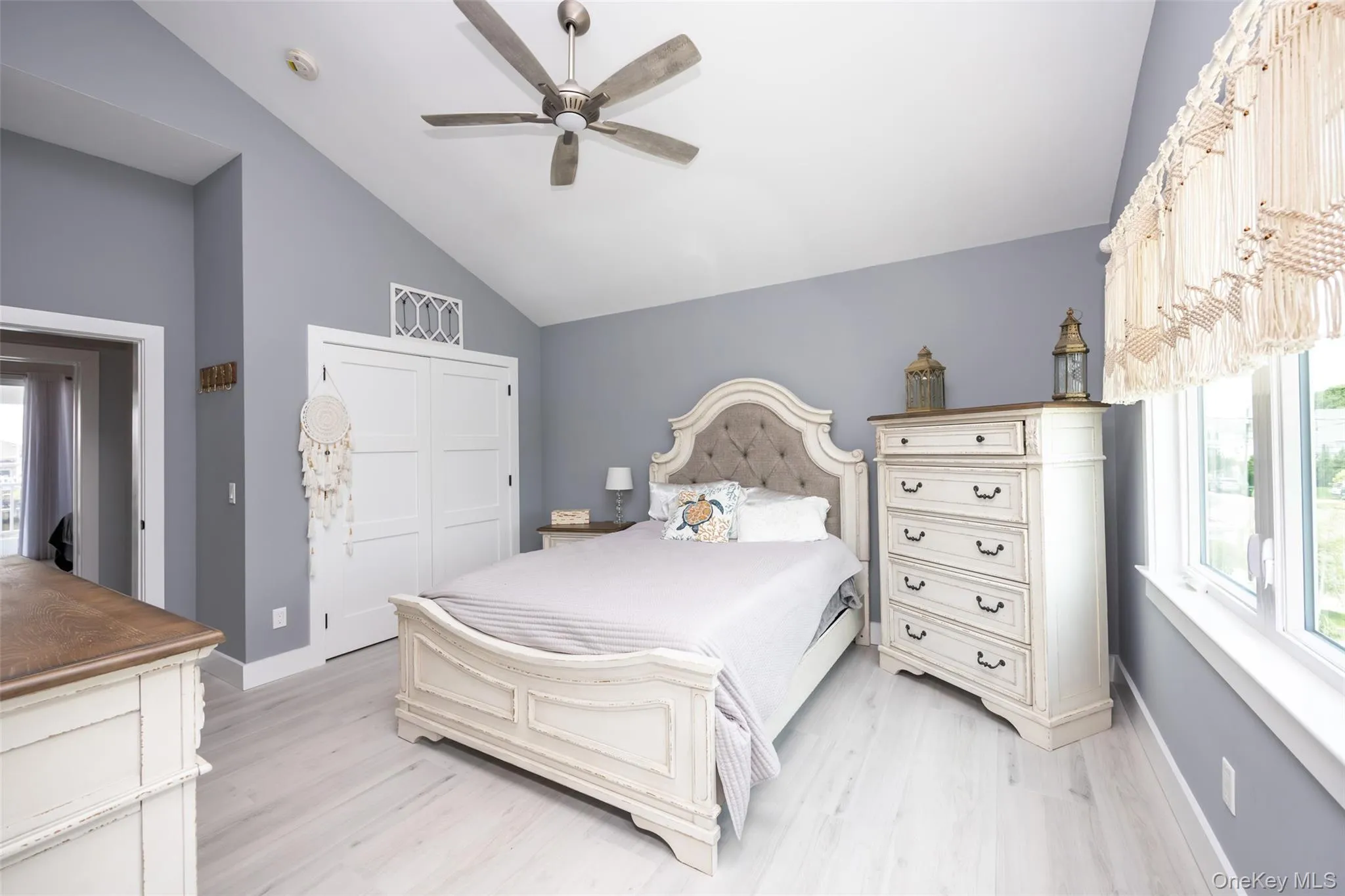 Bedroom with lofted ceiling, light wood-type flooring, a closet, and ceiling fan Bedroom with lofted ceiling, light wood-type flooring, a closet, and ceiling fan