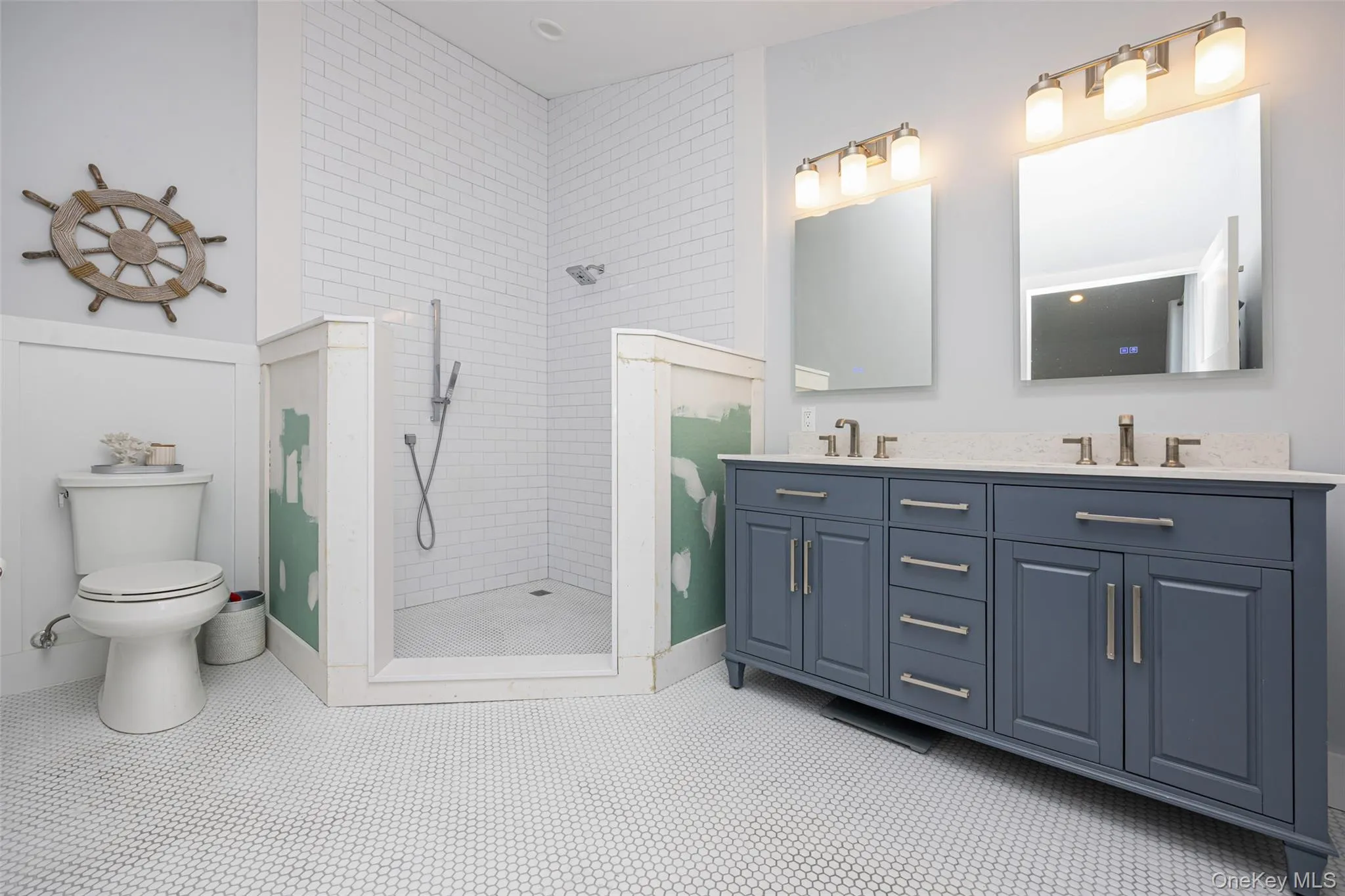 Bathroom featuring double vanity and a walk in shower Bathroom featuring double vanity and a walk in shower