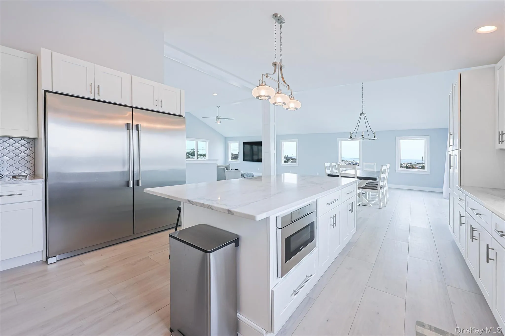 Kitchen with built in appliances, healthy amount of natural light, a center island, light wood-style flooring, and recessed lighting Kitchen with built in appliances, healthy amount of natural light, a center island, light wood-style flooring, and recessed lighting