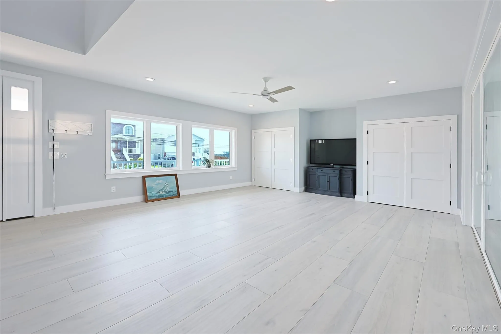 Unfurnished living room featuring a ceiling fan, recessed lighting, and light wood finished floors Unfurnished living room featuring a ceiling fan, recessed lighting, and light wood finished floors