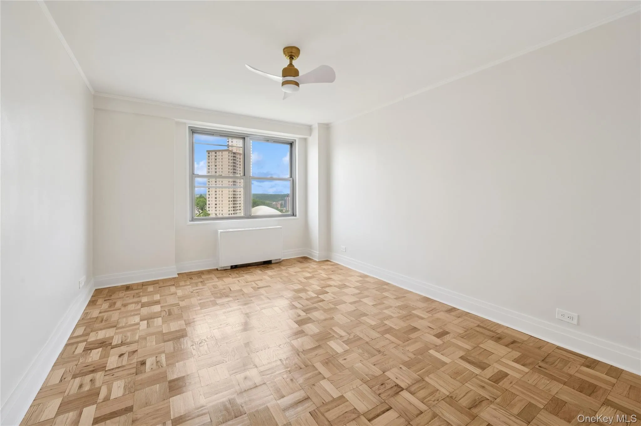 Spare room with radiator and ceiling fan Spare room with radiator and ceiling fan