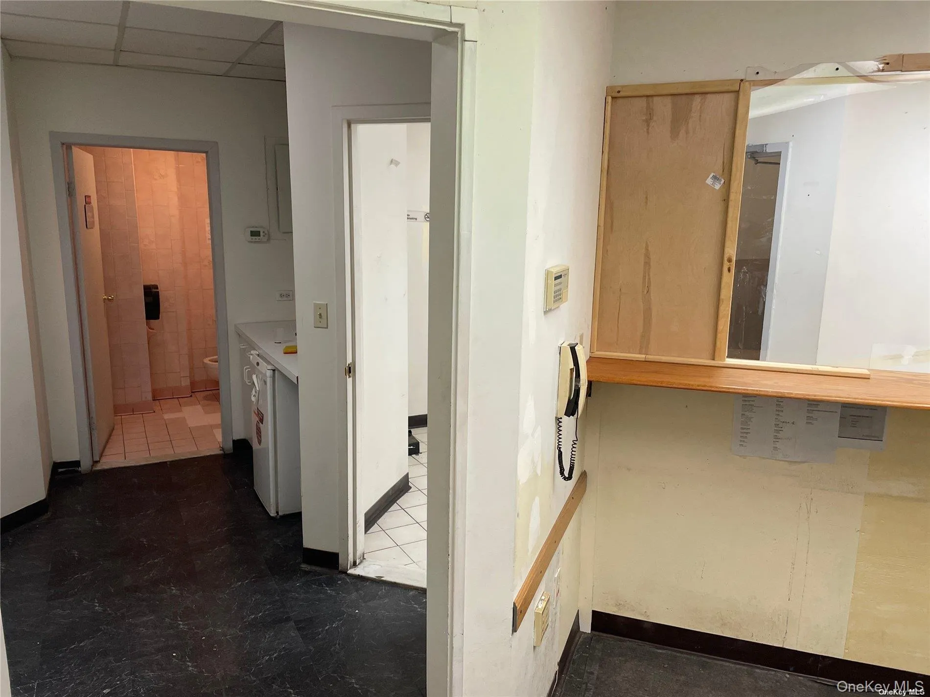 Corridor featuring a drop ceiling Corridor featuring a drop ceiling