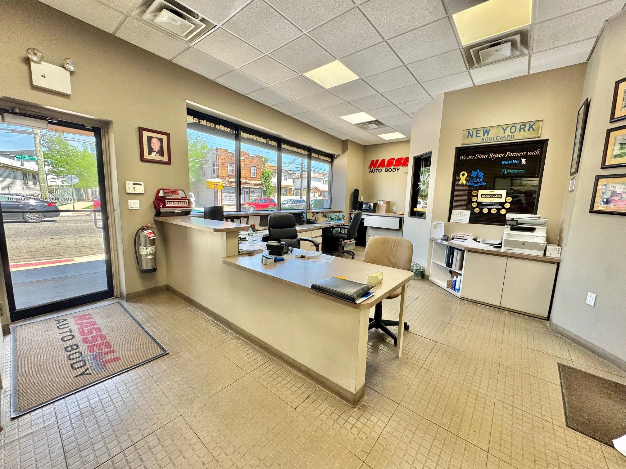 Tiled office with a drop ceiling and baseboards Tiled office with a drop ceiling and baseboards