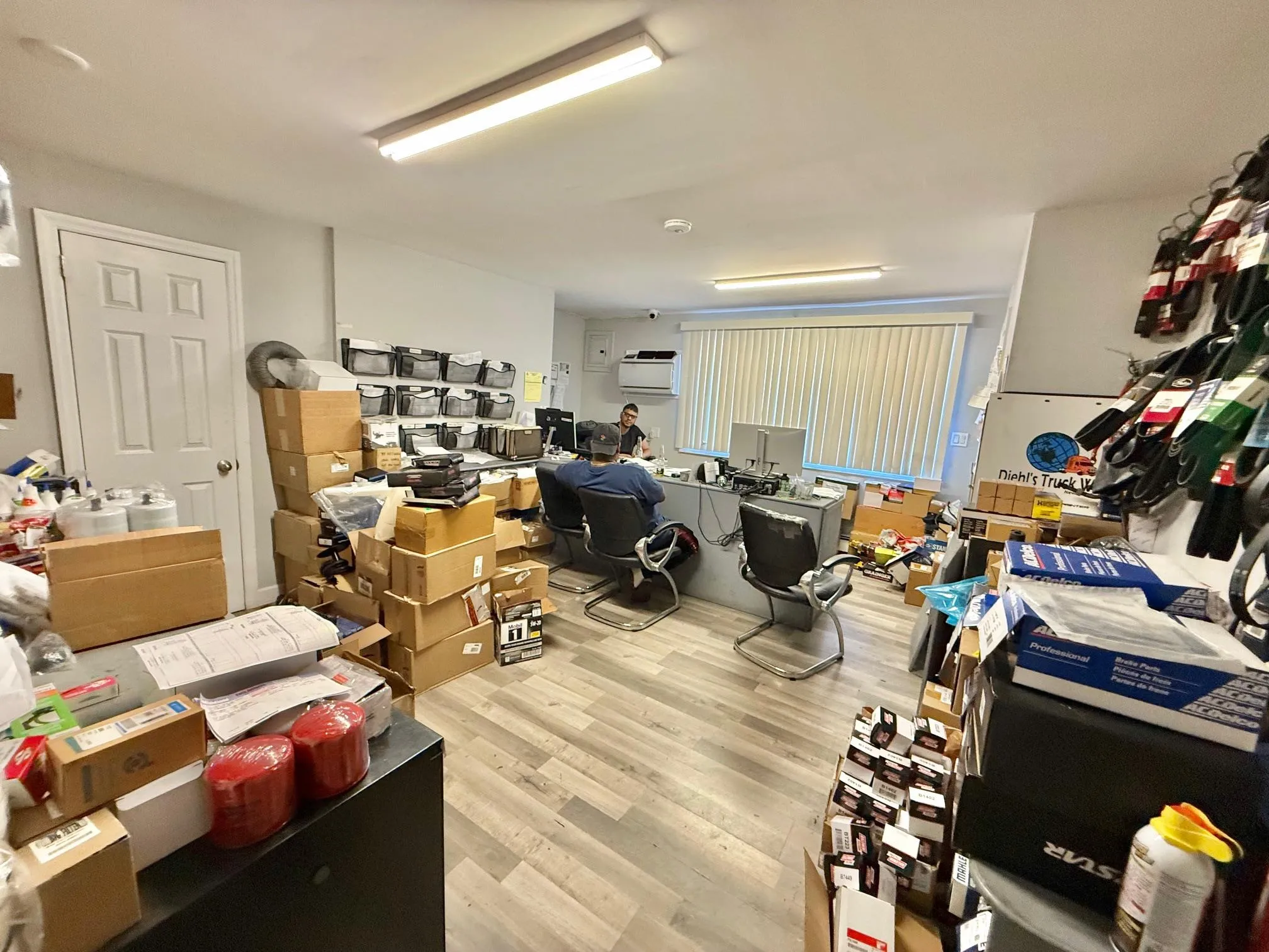 Office featuring a wall mounted AC and wood finished floors Office featuring a wall mounted AC and wood finished floors