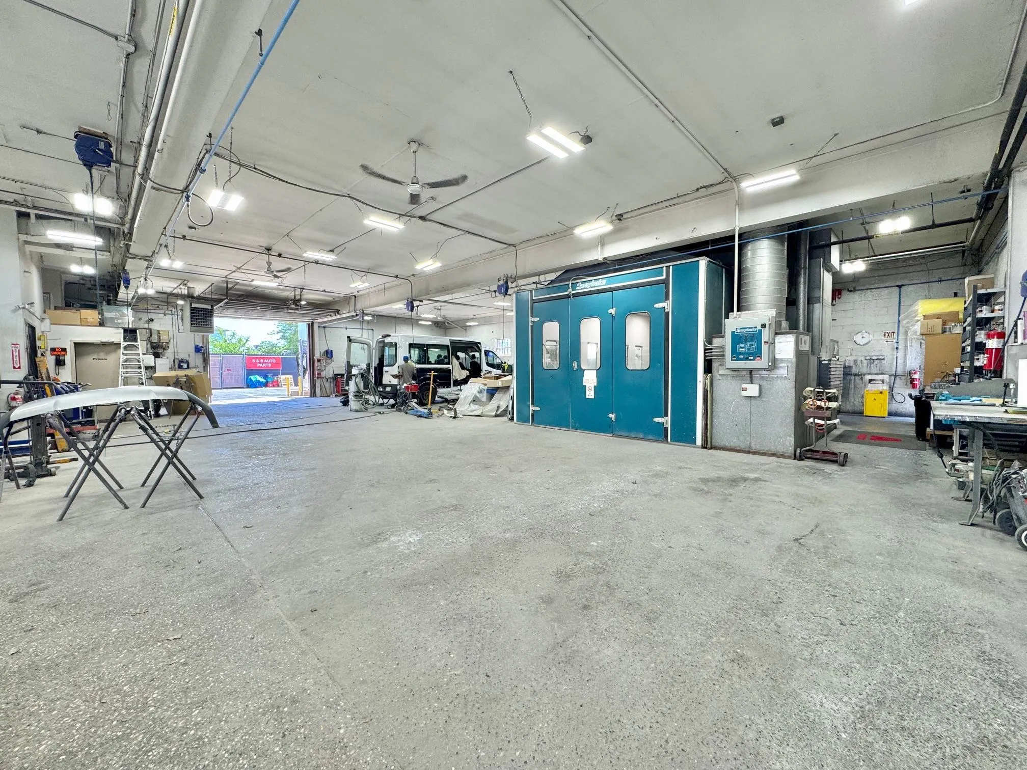 Garage featuring a workshop area and a ceiling fan Garage featuring a workshop area and a ceiling fan