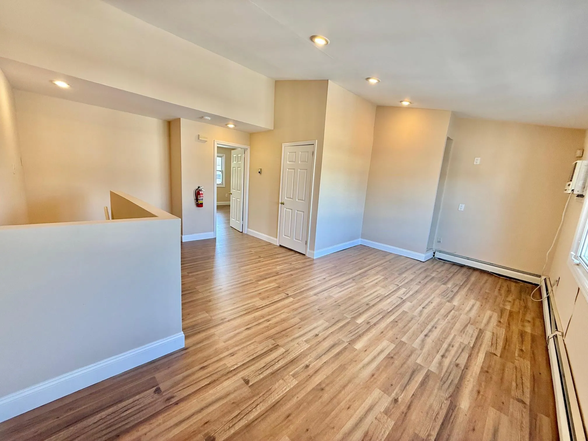 Spare room featuring light wood-style flooring, a baseboard radiator, and recessed lighting Spare room featuring light wood-style flooring, a baseboard radiator, and recessed lighting