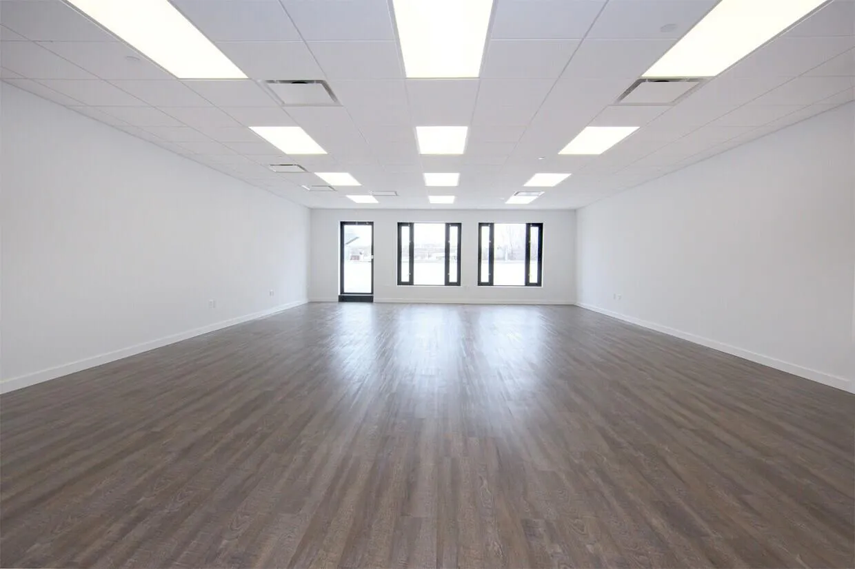 Spare room featuring dark wood finished floors and a drop ceiling Spare room featuring dark wood finished floors and a drop ceiling