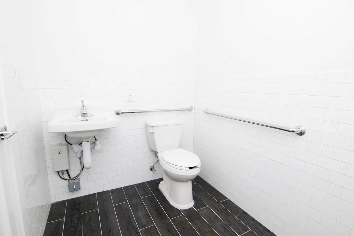 Half bath with toilet and tile walls Half bath with toilet and tile walls