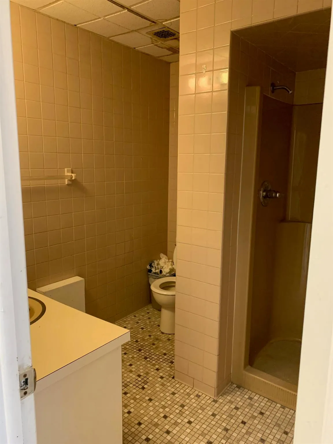 Full bathroom featuring a shower stall, tile patterned flooring, tile walls, vanity, and a paneled ceiling Full bathroom featuring a shower stall, tile patterned flooring, tile walls, vanity, and a paneled ceiling