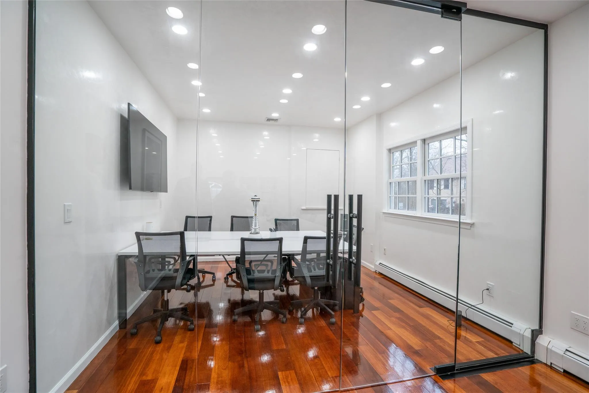 Office area with a baseboard heating unit, recessed lighting, and hardwood / wood-style flooring Office area with a baseboard heating unit, recessed lighting, and hardwood / wood-style flooring