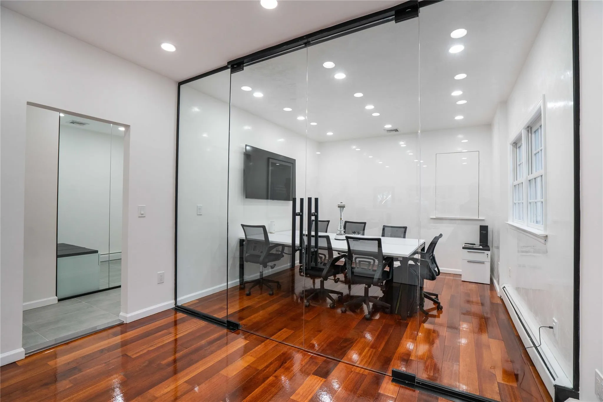 Dining space with a desk, baseboard heating, wood-type flooring, and recessed lighting Dining space with a desk, baseboard heating, wood-type flooring, and recessed lighting