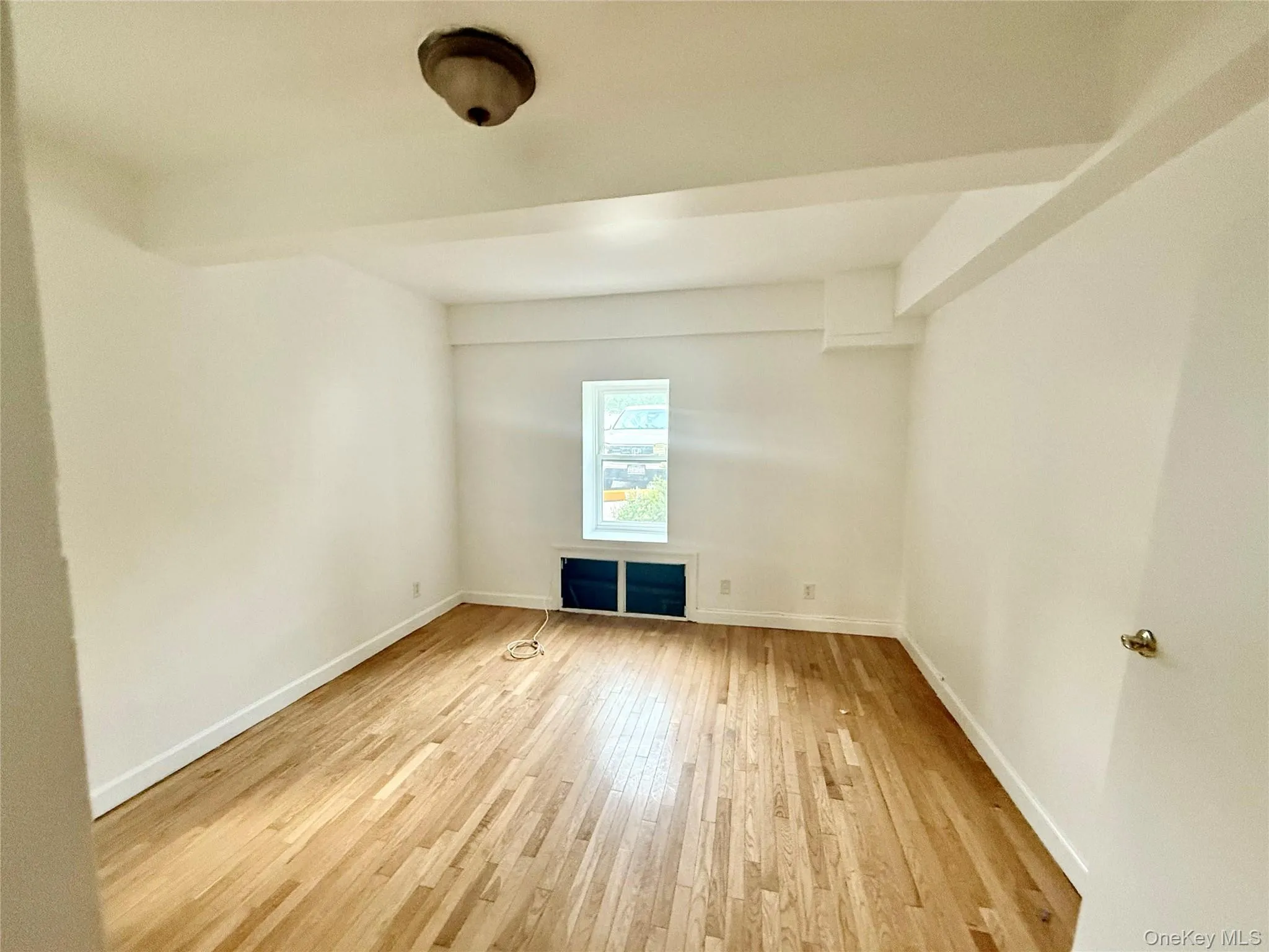 Bedroom featuring light wood-style flooring and baseboards Bedroom featuring light wood-style flooring and baseboards