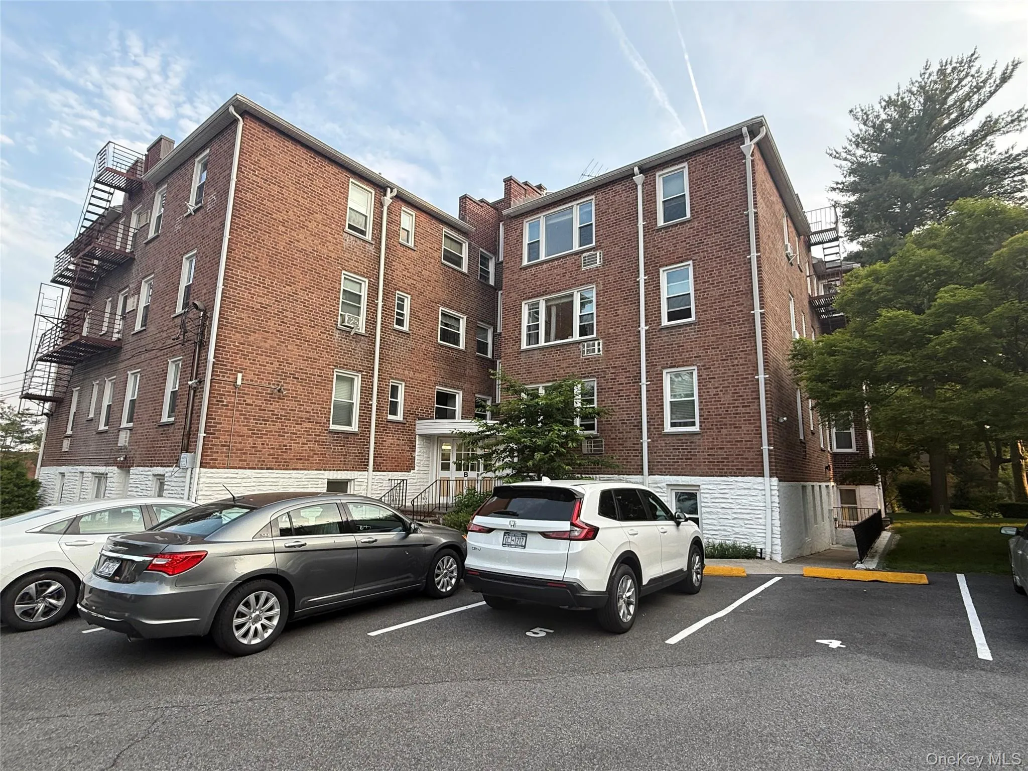View of property featuring assigned parking View of property featuring assigned parking