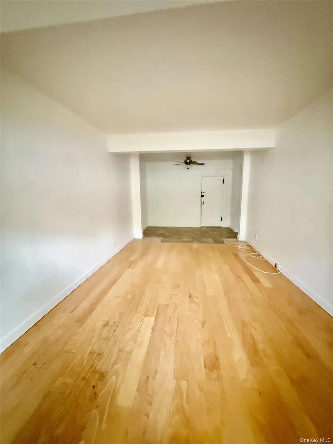 2nd view of living room featuring light wood-style flooring and baseboards 2nd view of living room featuring light wood-style flooring and baseboards