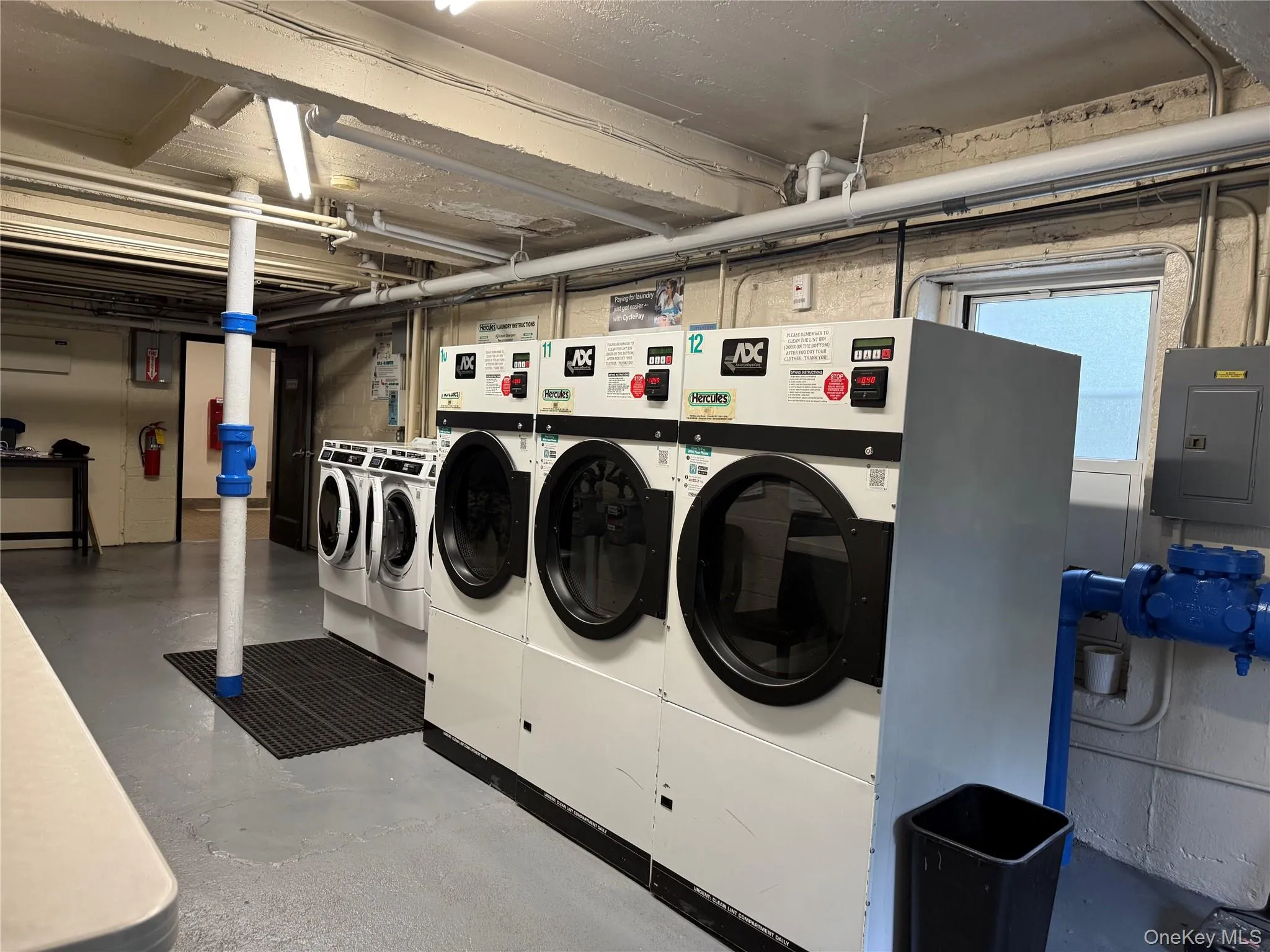 Shared laundry featuring electric panel and separate washer and dryer Shared laundry featuring electric panel and separate washer and dryer