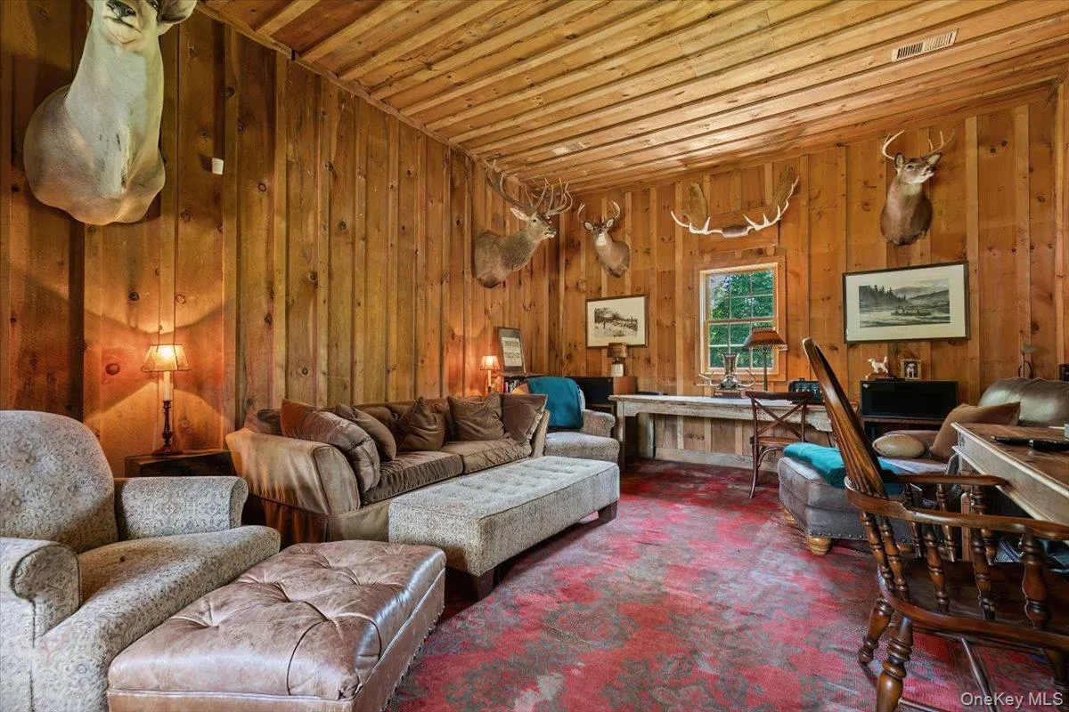 Living area featuring wood walls and wood ceiling Living area featuring wood walls and wood ceiling