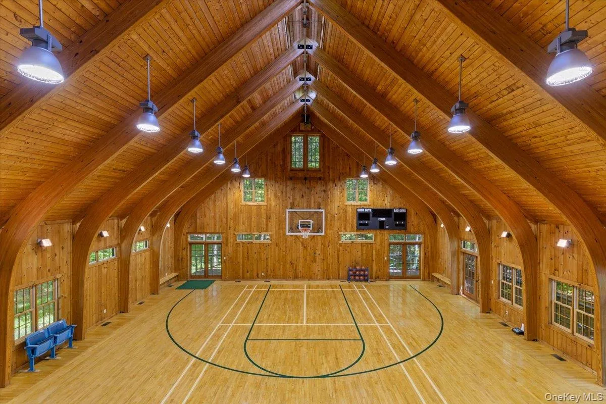 View of basketball court featuring healthy amount of natural light and basketball hoop View of basketball court featuring healthy amount of natural light and basketball hoop