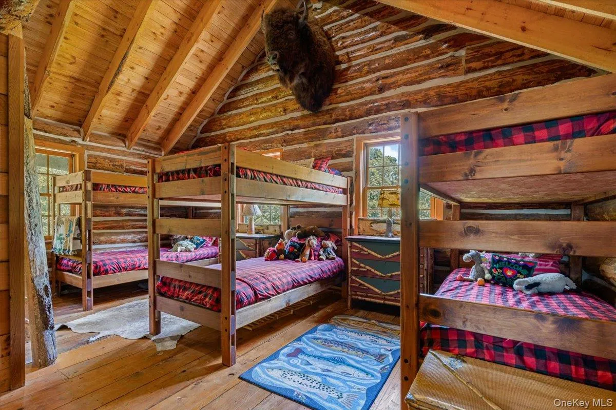 Bedroom featuring wood-type flooring and wooden ceiling Bedroom featuring wood-type flooring and wooden ceiling