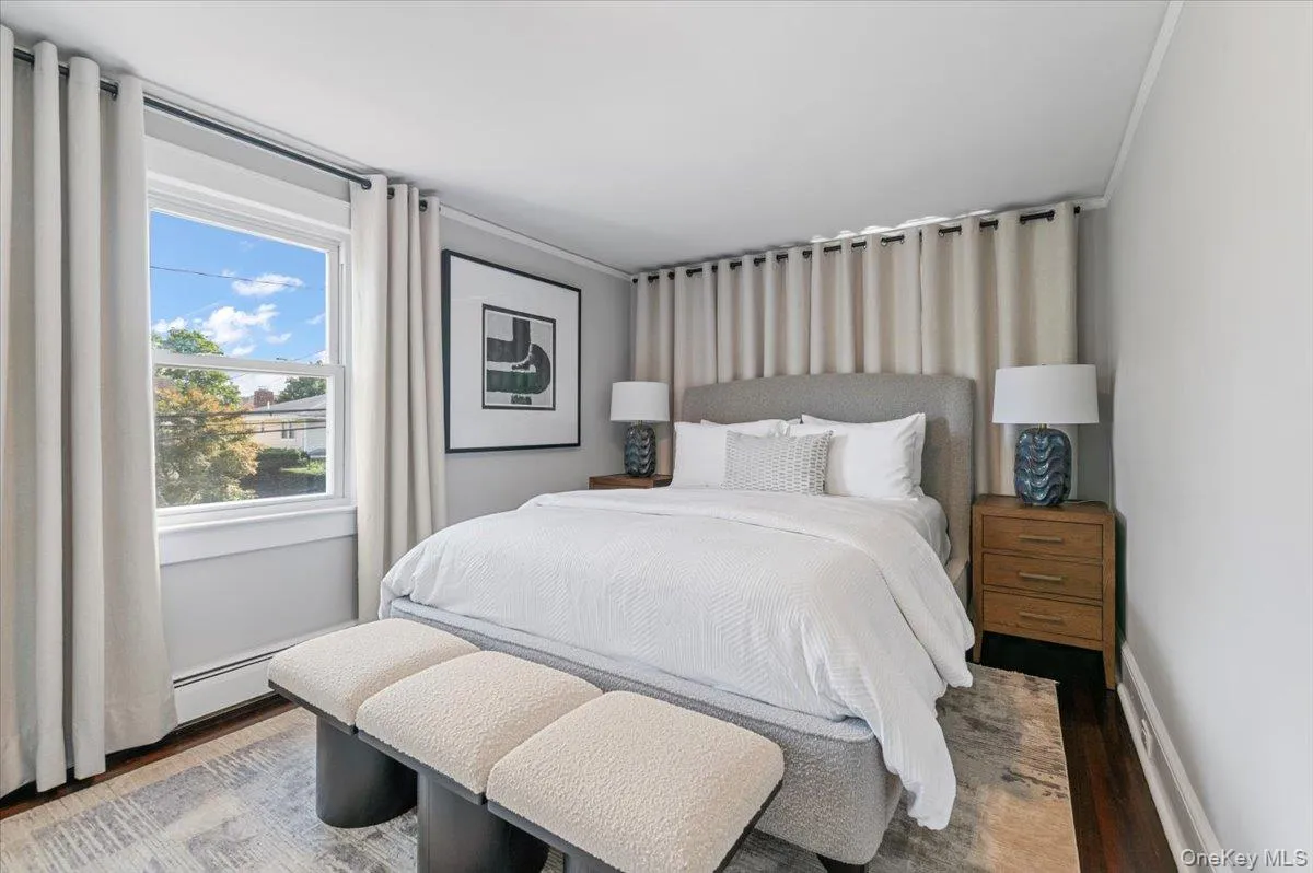 Bedroom with wood finished floors and baseboards Bedroom with wood finished floors and baseboards