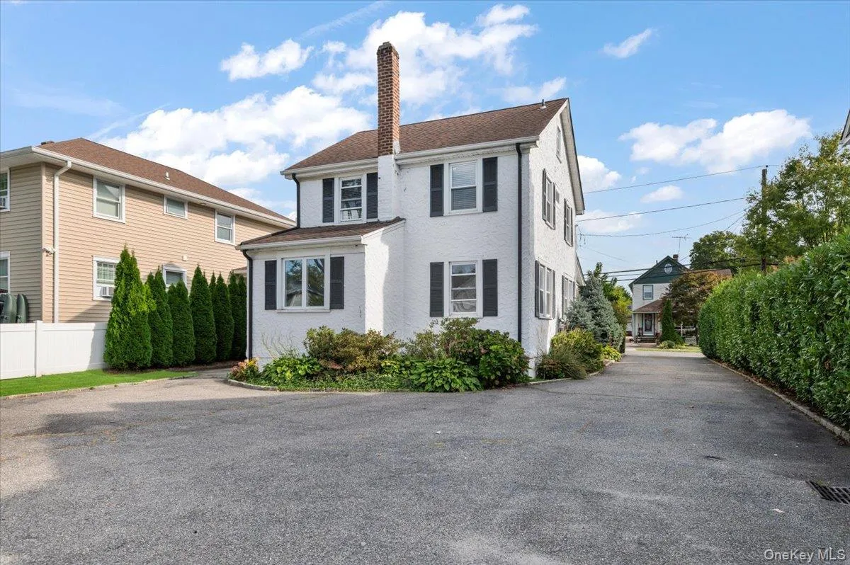 View of front facade featuring a chimney View of front facade featuring a chimney