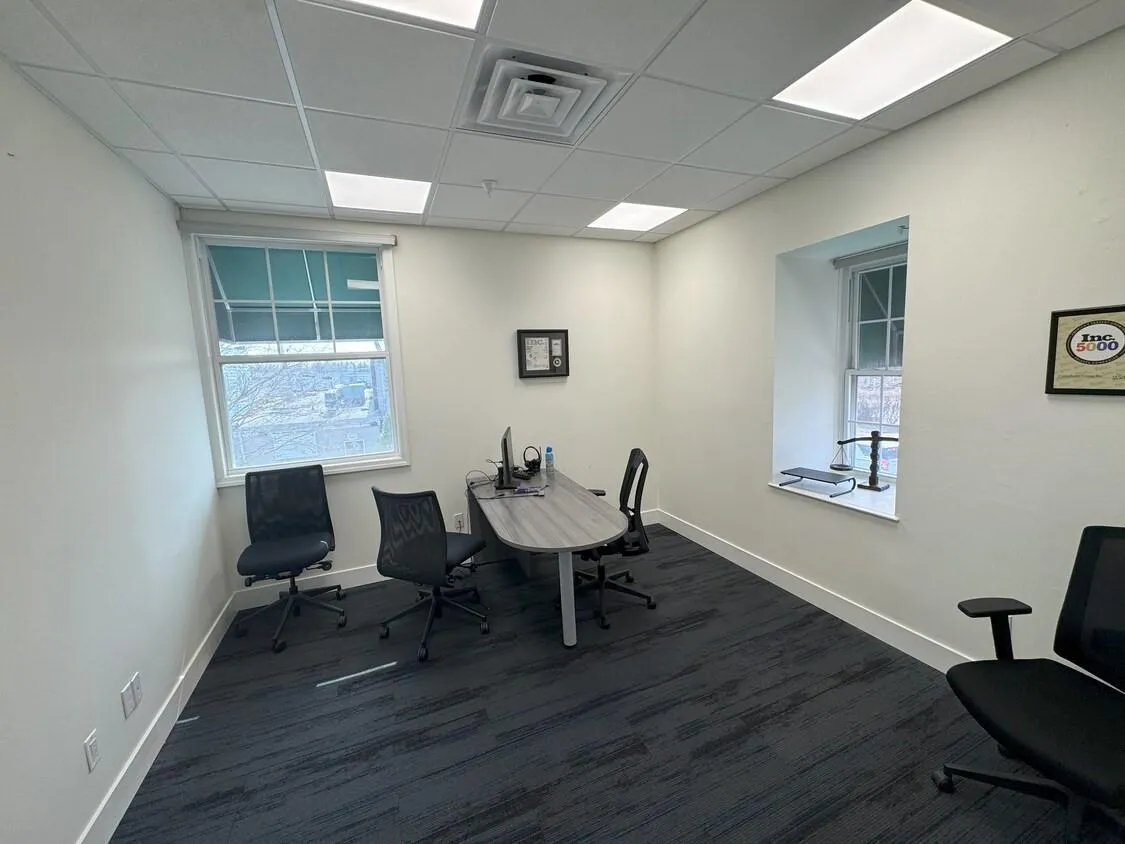 Office space with dark wood-style flooring and a drop ceiling Office space with dark wood-style flooring and a drop ceiling