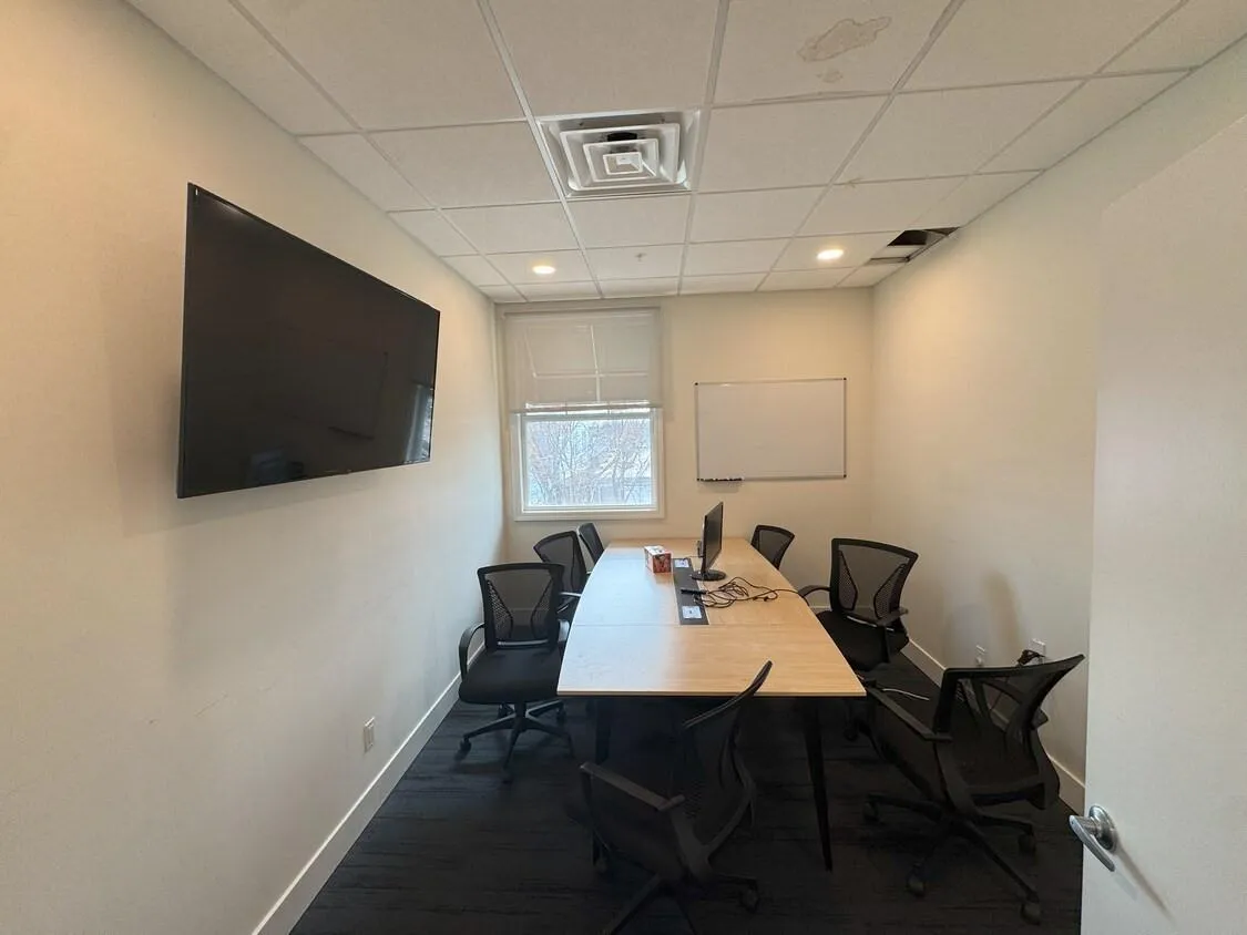 Office space with a paneled ceiling and wood finished floors Office space with a paneled ceiling and wood finished floors