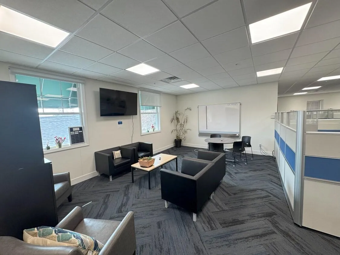 Living room featuring carpet and a drop ceiling Living room featuring carpet and a drop ceiling