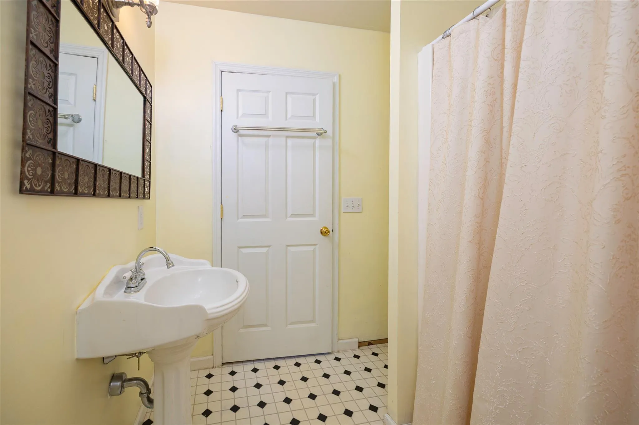 Full bathroom with tile patterned floors and a shower with curtain Full bathroom with tile patterned floors and a shower with curtain