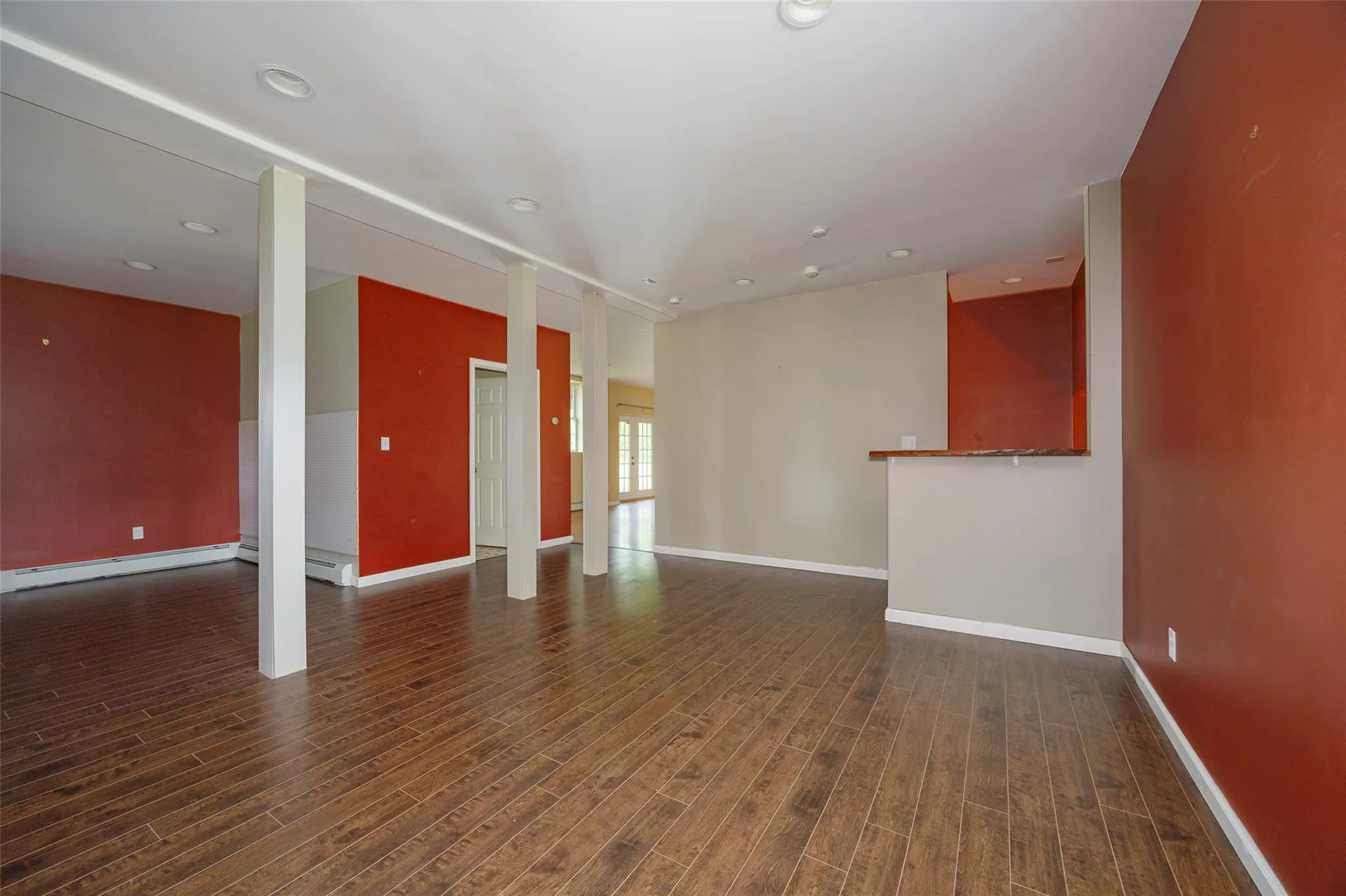 Empty room with dark wood-style floors and recessed lighting Empty room with dark wood-style floors and recessed lighting