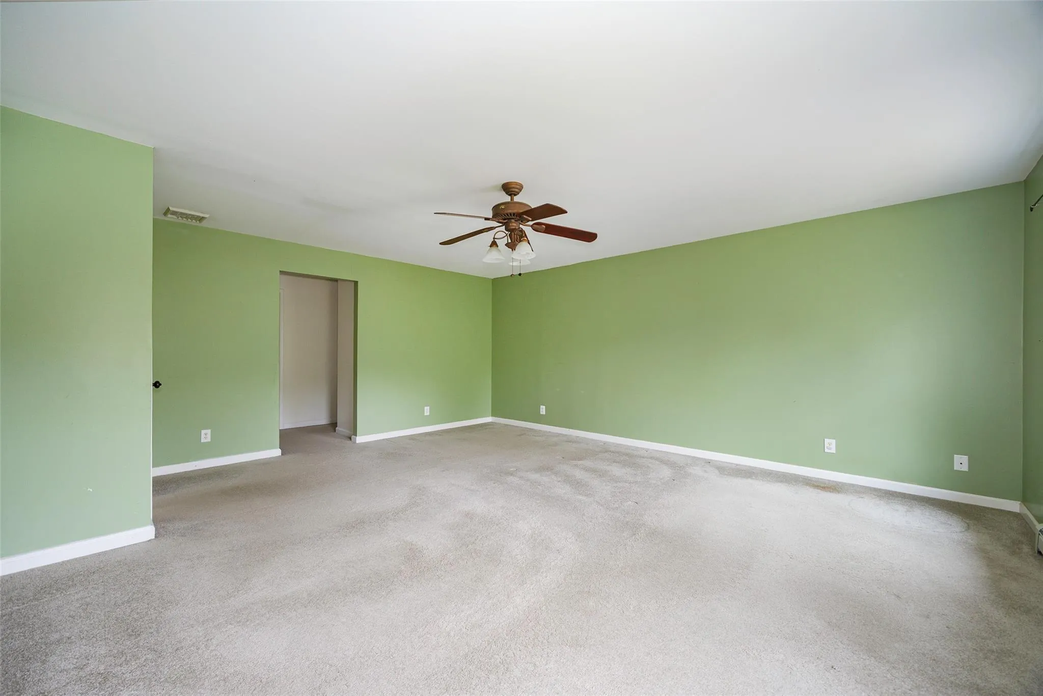 Spare room with a ceiling fan and light carpet Spare room with a ceiling fan and light carpet