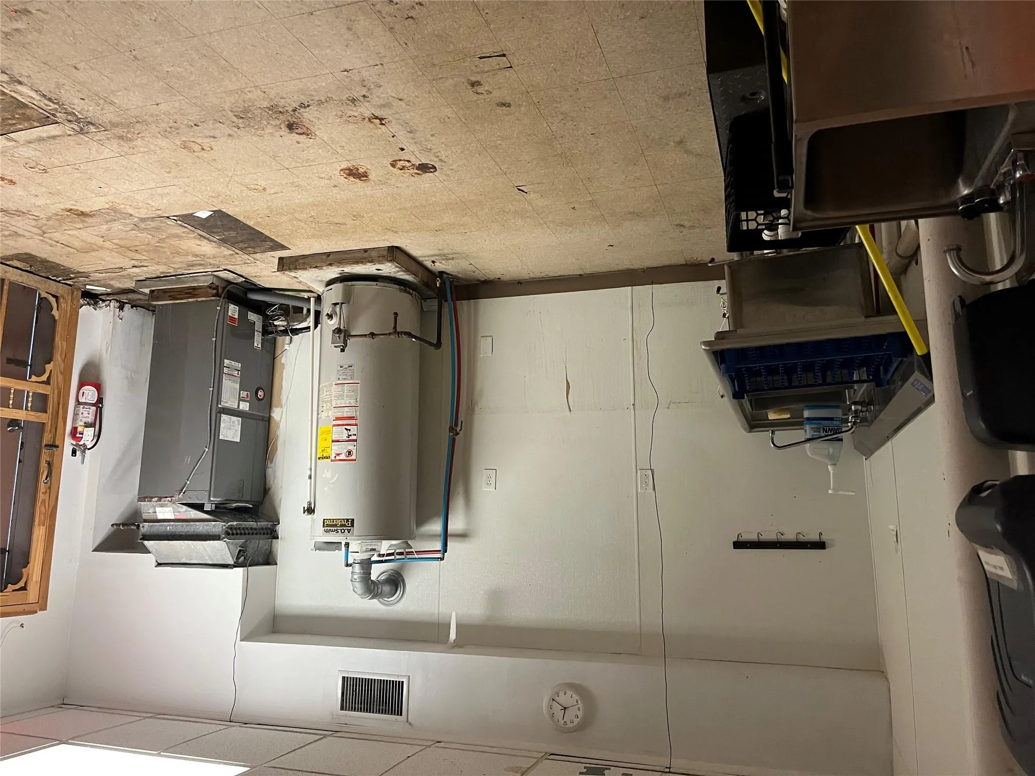 Utilities featuring water heater and heating unit Utilities featuring water heater and heating unit