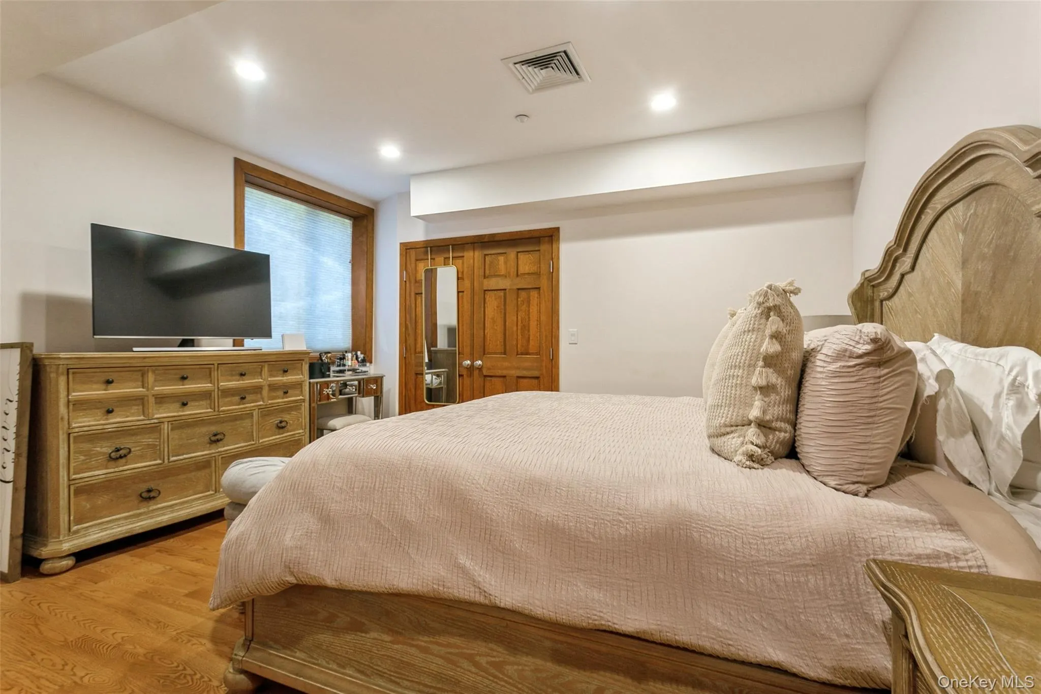 Bedroom featuring wood finished floors and recessed lighting Bedroom featuring wood finished floors and recessed lighting