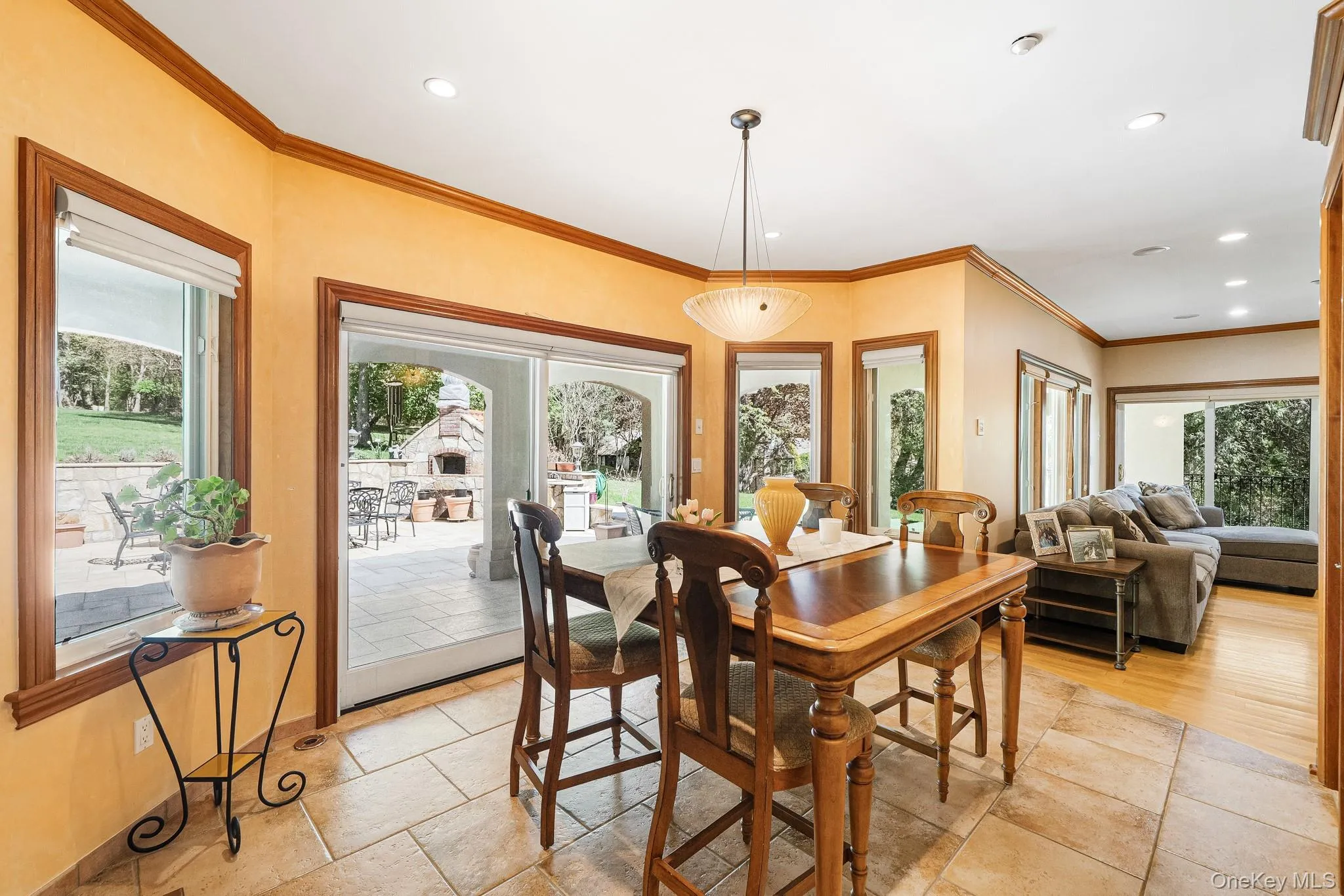 Dining room with recessed lighting, stone tile floors, and ornamental molding Dining room with recessed lighting, stone tile floors, and ornamental molding