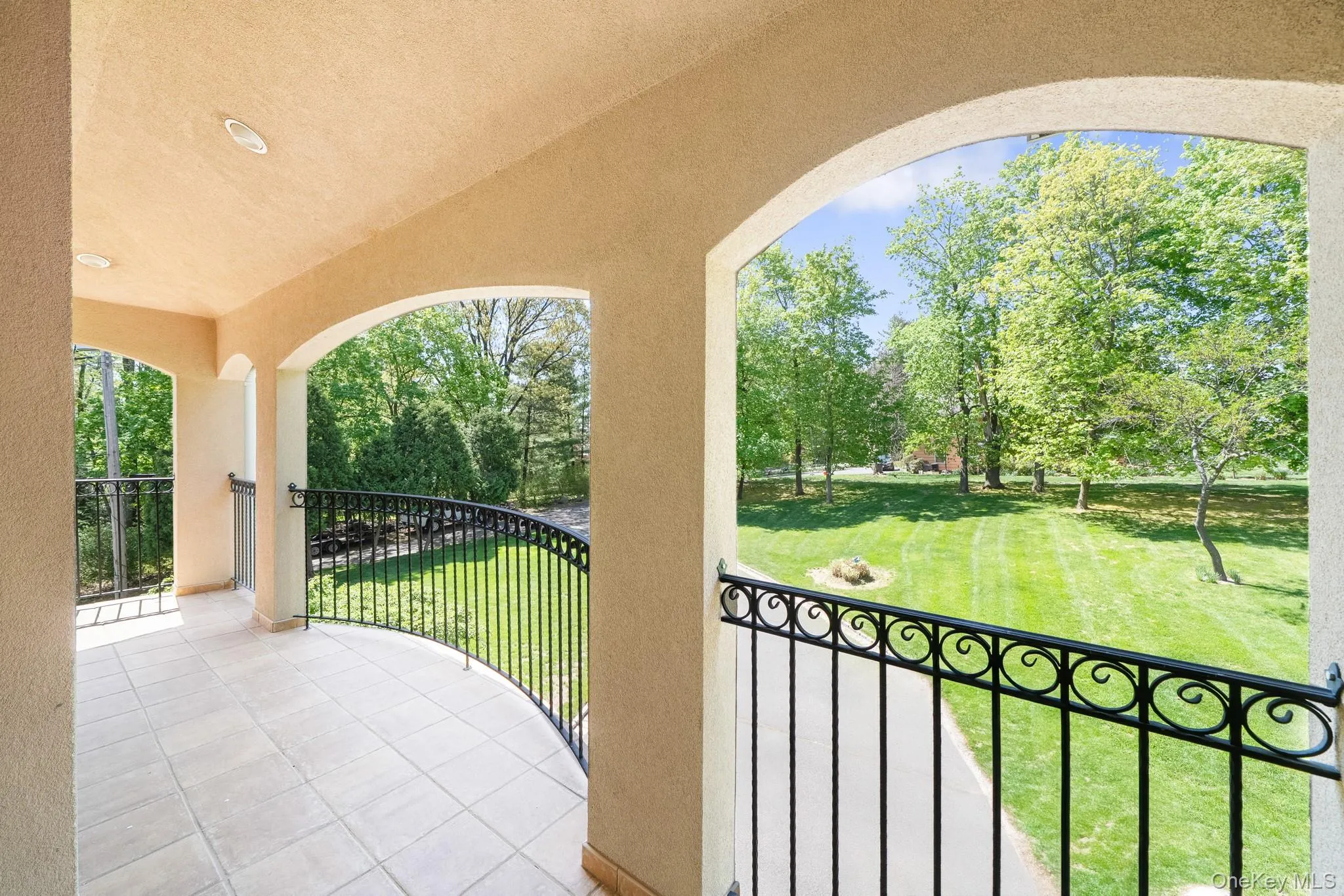 Patio / terrace featuring view of wooded area and a lawn Patio / terrace featuring view of wooded area and a lawn