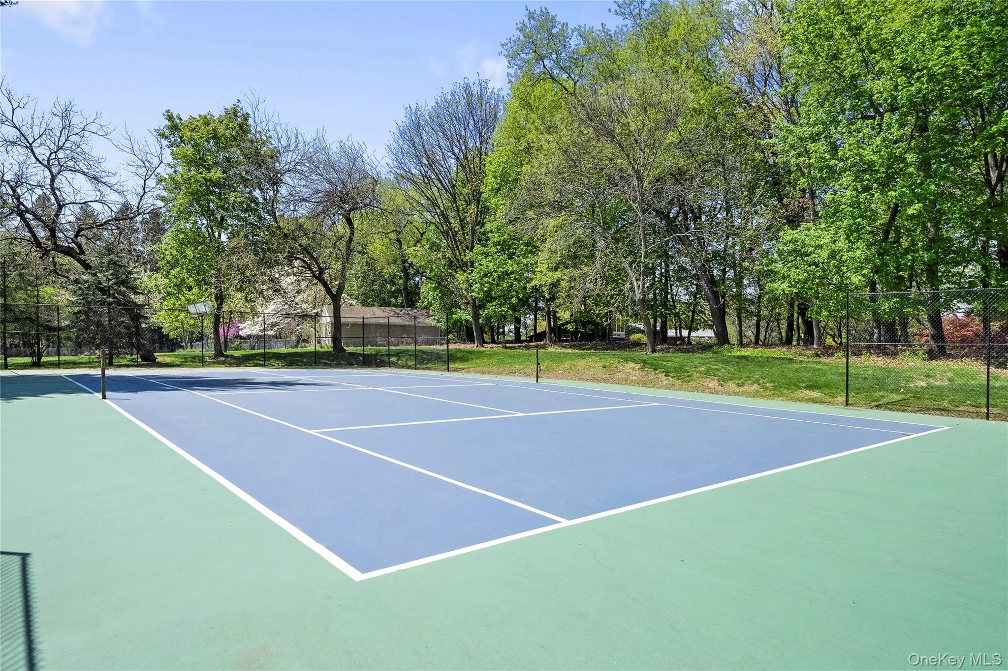 View of tennis court featuring community basketball court View of tennis court featuring community basketball court