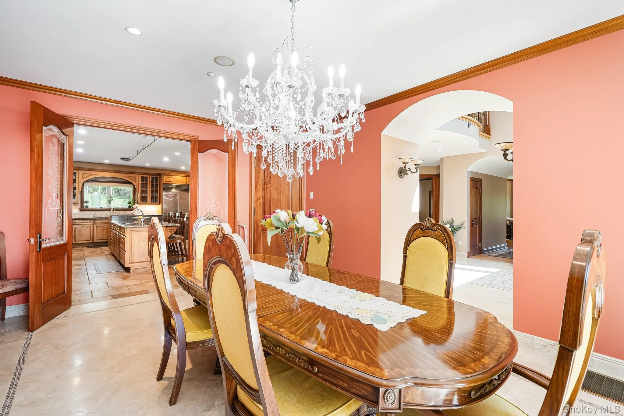 Dining area featuring arched walkways, recessed lighting, ornamental molding, and a chandelier Dining area featuring arched walkways, recessed lighting, ornamental molding, and a chandelier