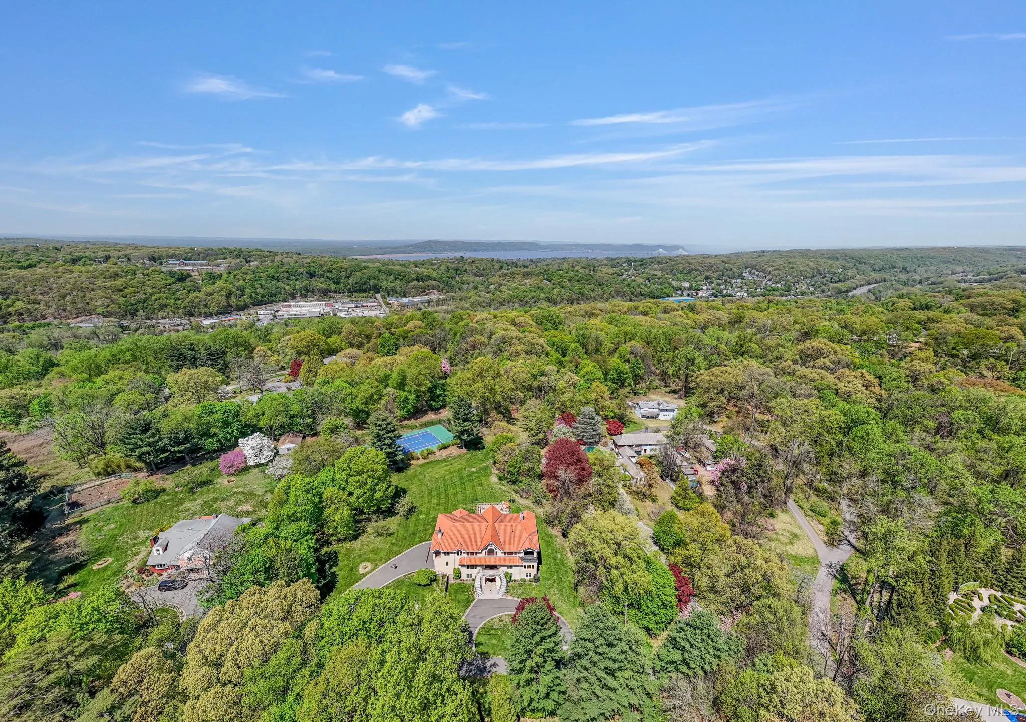 Aerial view of property and surrounding area with a forest Aerial view of property and surrounding area with a forest