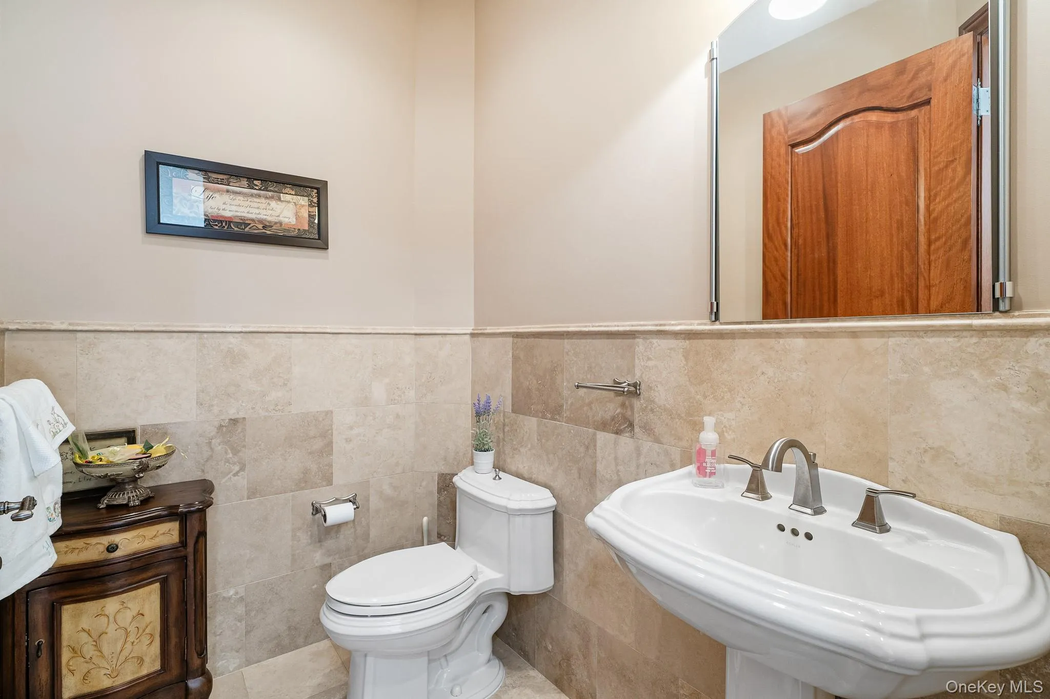 Bathroom with wainscoting and tile walls Bathroom with wainscoting and tile walls
