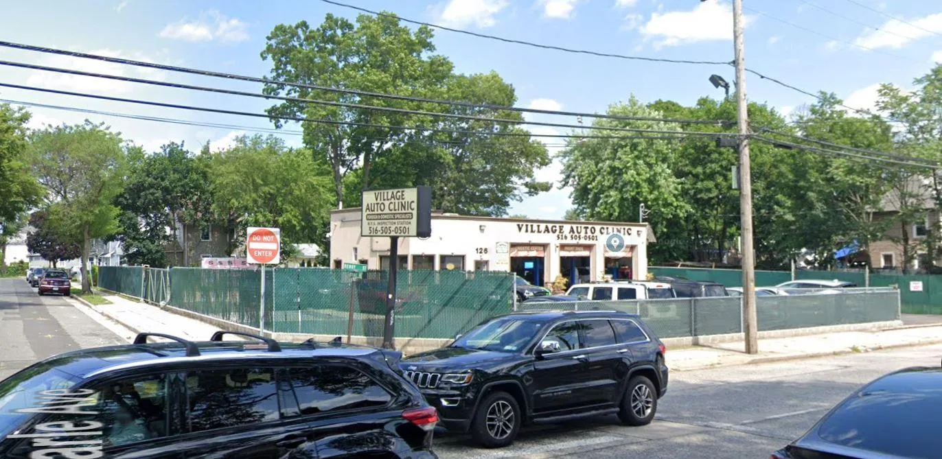 View of asphalt street featuring sidewalks, curbs, and traffic signs View of asphalt street featuring sidewalks, curbs, and traffic signs