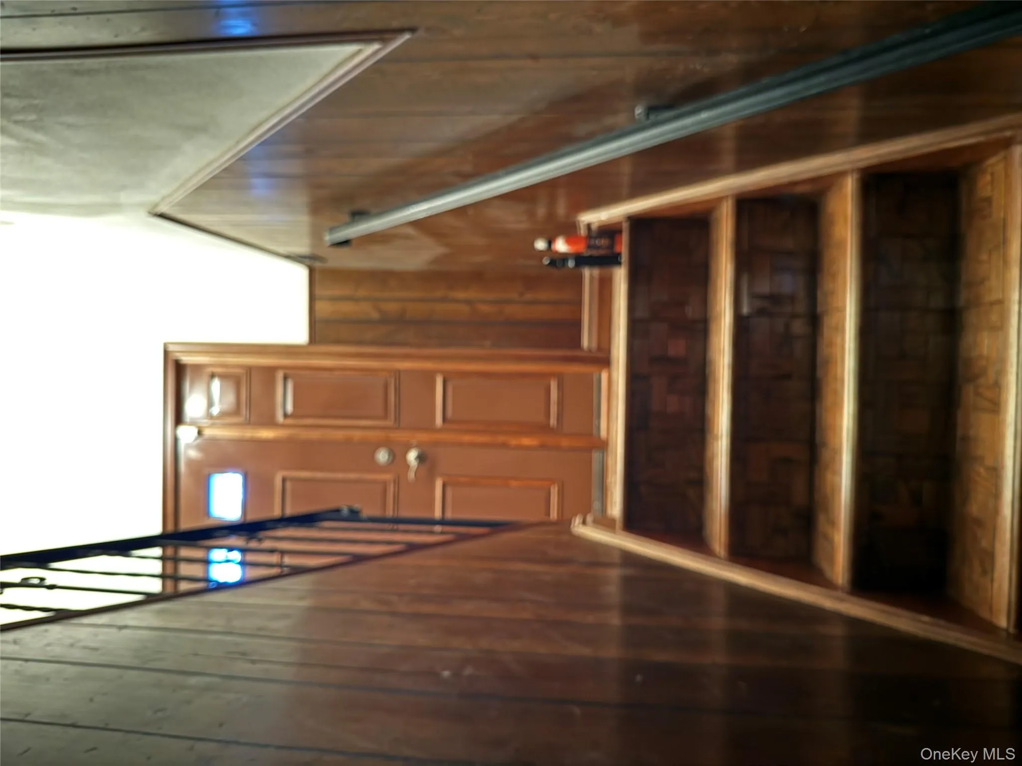 REAR Stairway to backyard featuring wood walls and wood finished floors REAR Stairway to backyard featuring wood walls and wood finished floors