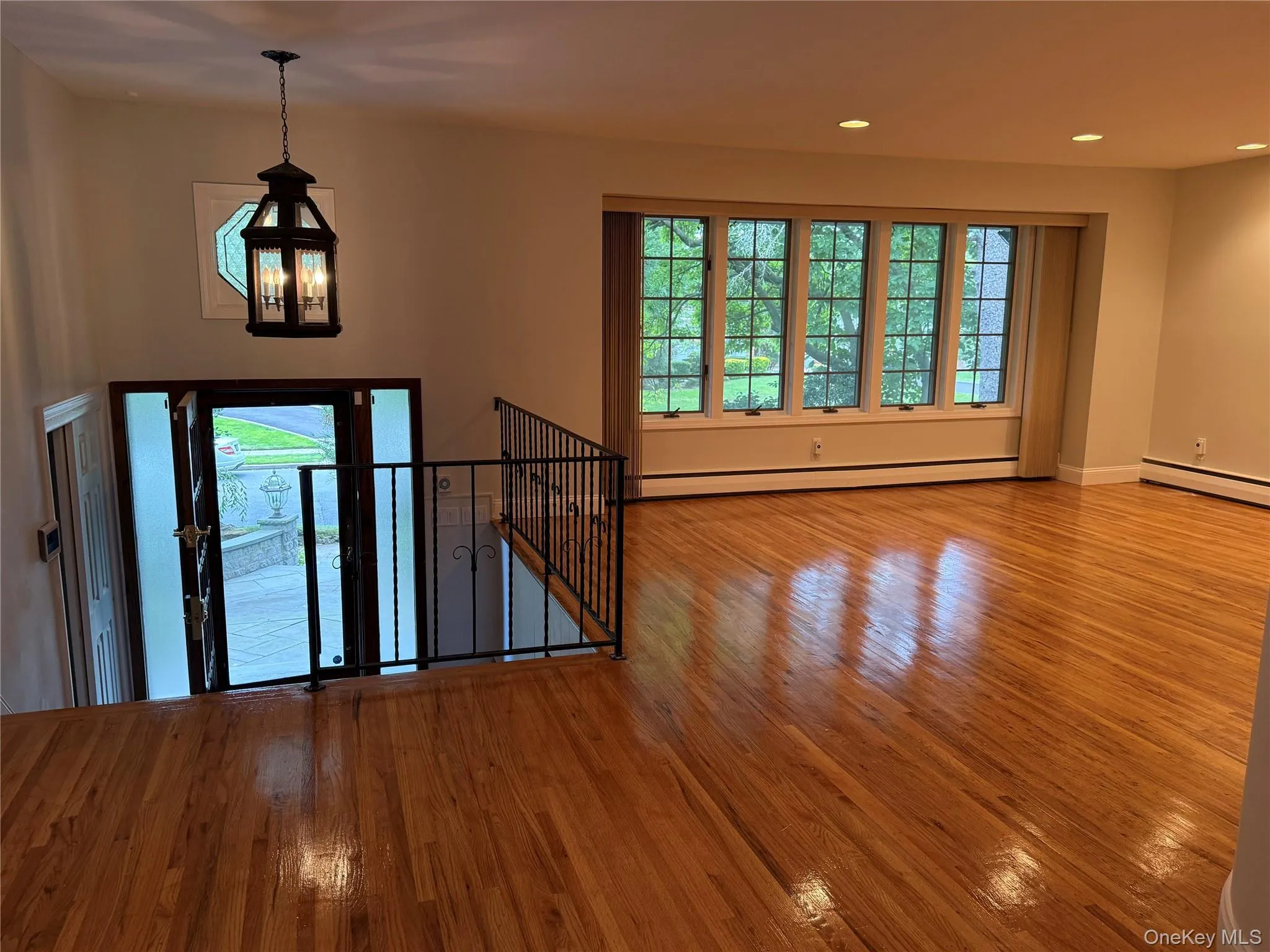 Entryway featuring wood-type flooring, baseboard heating, and recessed lighting Entryway featuring wood-type flooring, baseboard heating, and recessed lighting