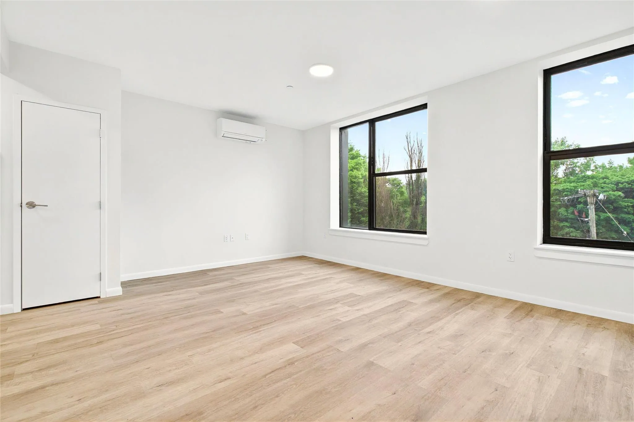 Front living area showing large windows and additional closet. Front living area showing large windows and additional closet.