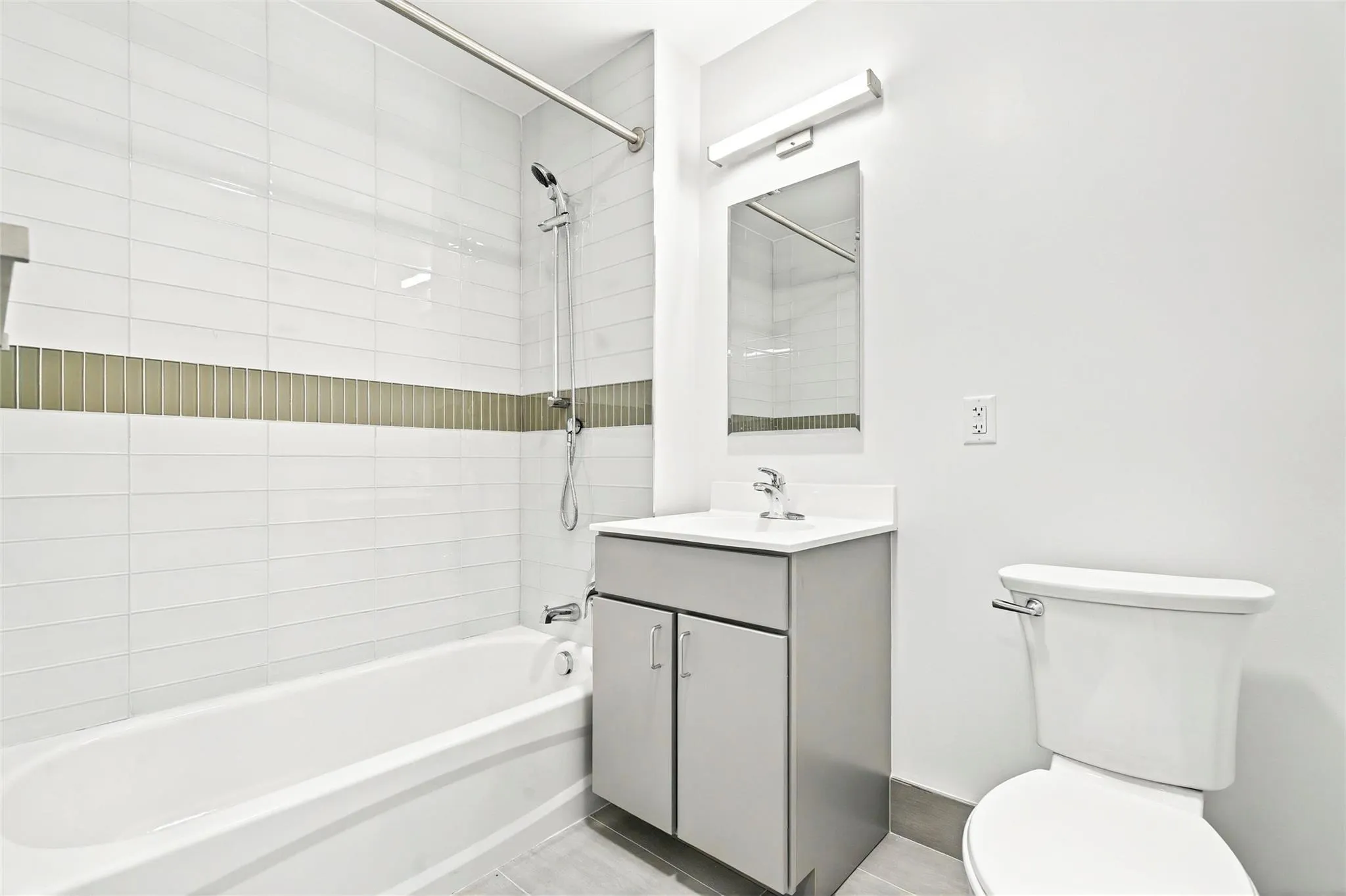 Full bathroom featuring toilet, vanity, and shower / bathtub combination - wide view Full bathroom featuring toilet, vanity, and shower / bathtub combination - wide view