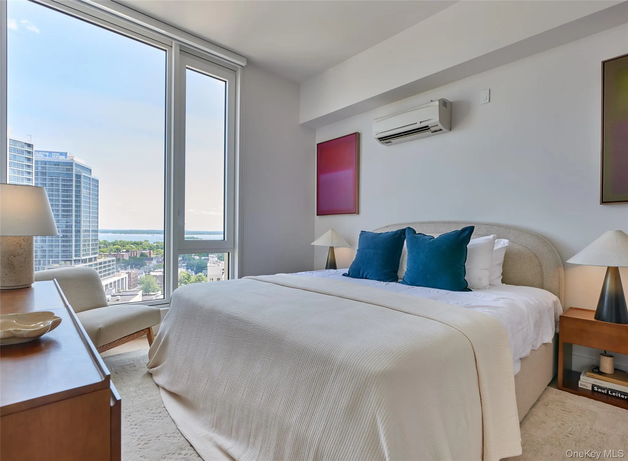 Bedroom with a wall mounted AC and a view of city Bedroom with a wall mounted AC and a view of city