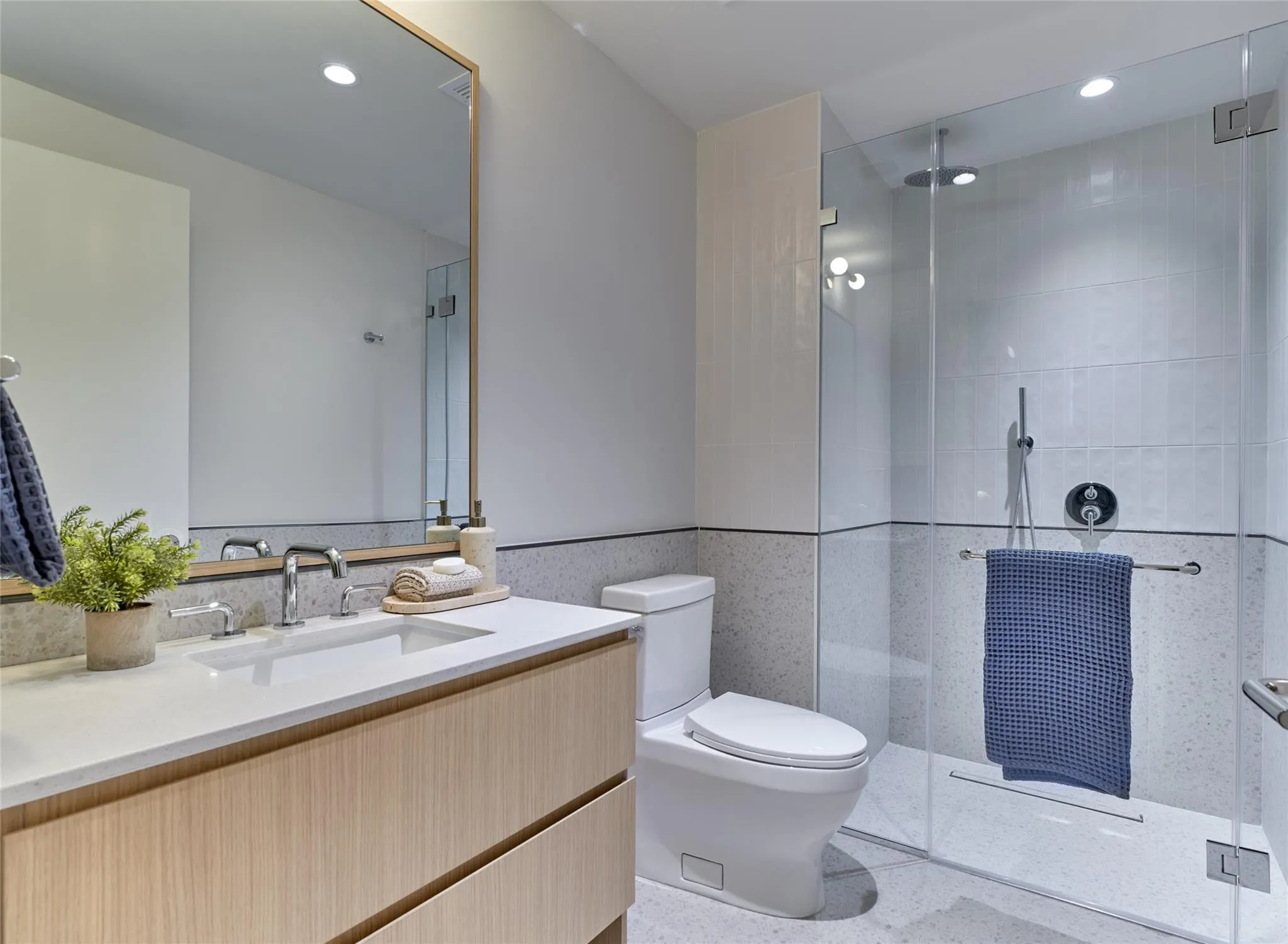 Bathroom with vanity, a tile shower, speckled floor, and recessed lighting Bathroom with vanity, a tile shower, speckled floor, and recessed lighting
