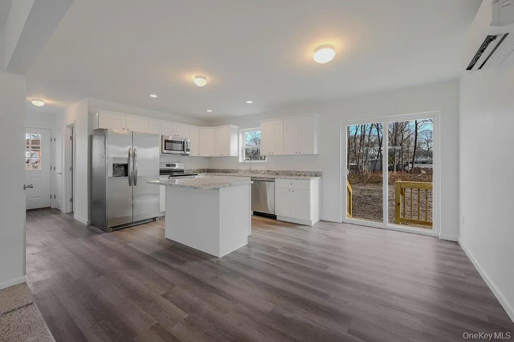 Kitchen with stone countertops, white soft close cabinets plus stainless appliances Kitchen with stone countertops, white soft close cabinets plus stainless appliances