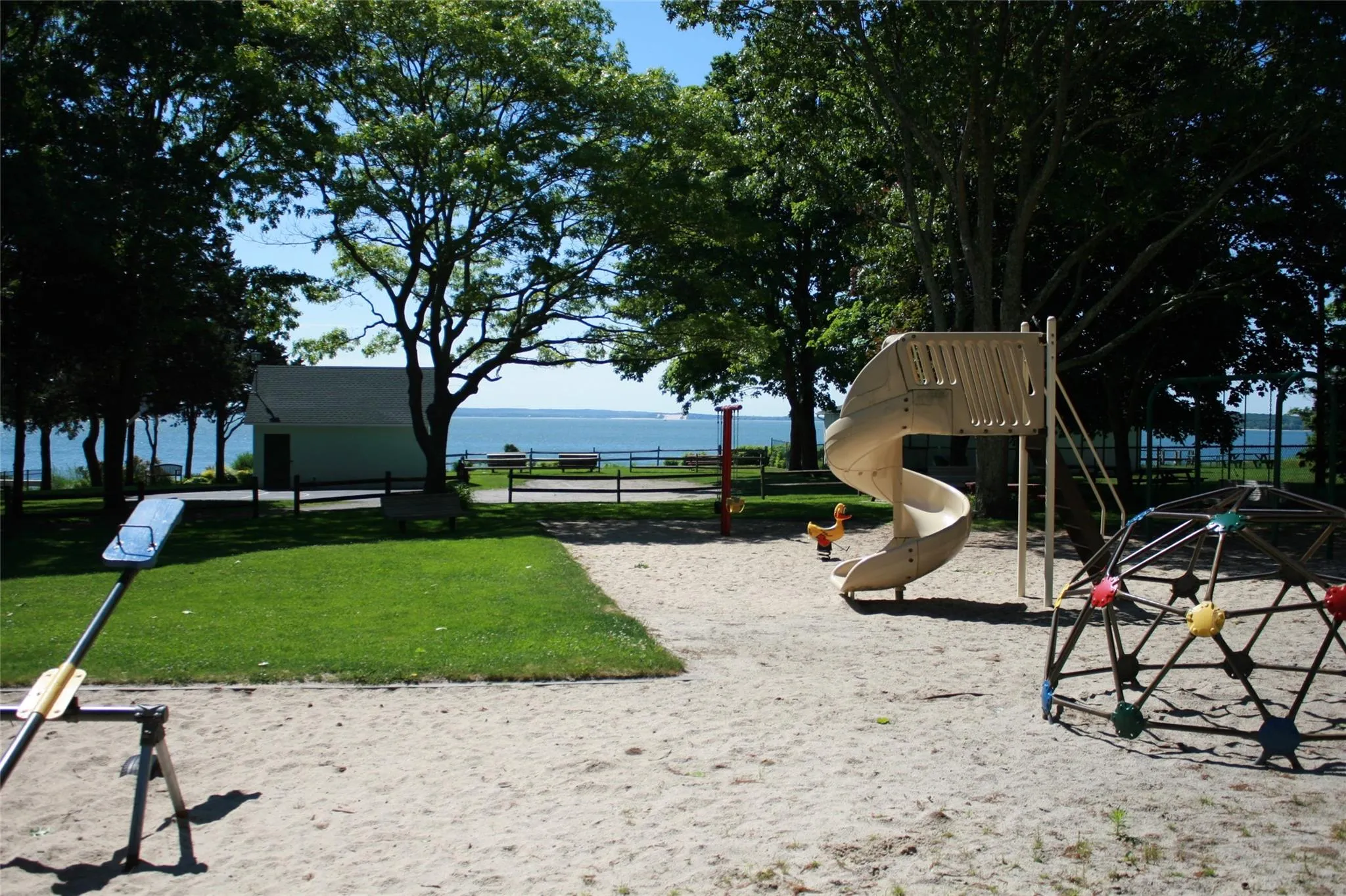 Community play area featuring a water view Community play area featuring a water view