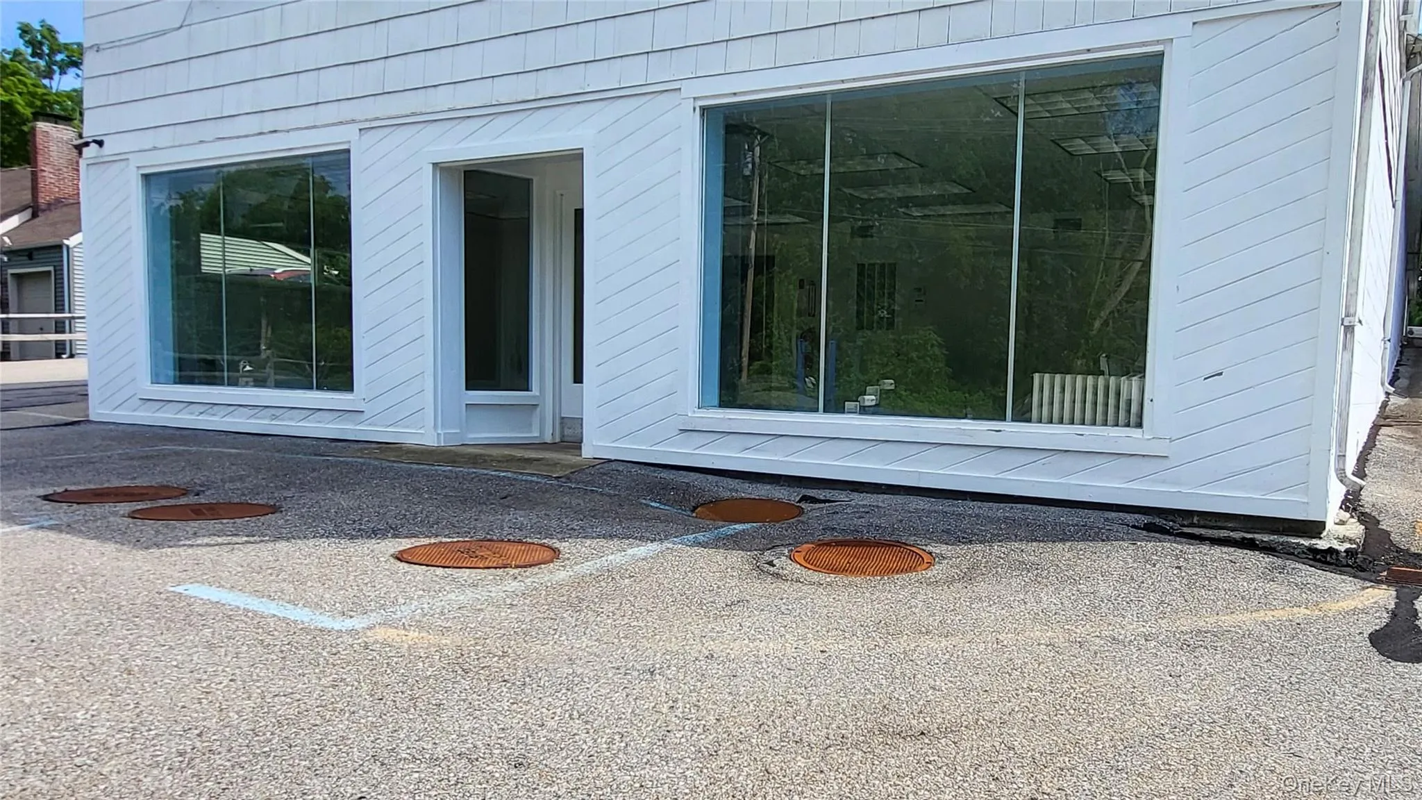 Doorway to property featuring large windows Doorway to property featuring large windows